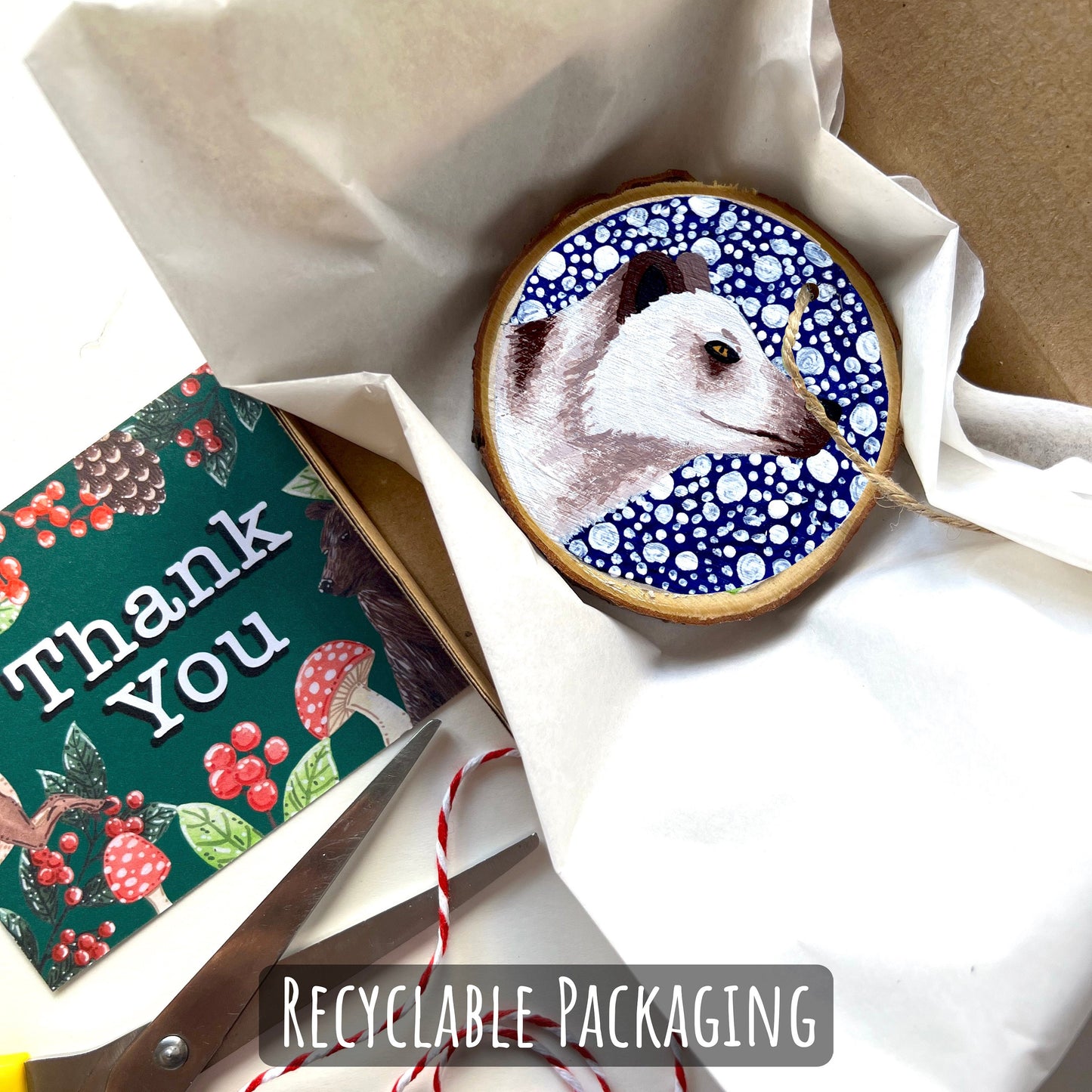 showing how your ornament will be packed, wrapped in tissue and placed into a box with a thank you card.