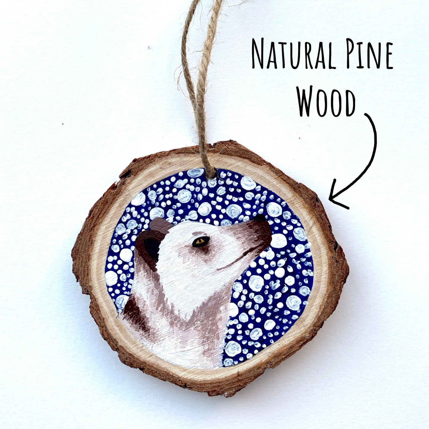 Arctic Fox Wood Slice Ornament laying flat on a white surface with the font natural pine wood.