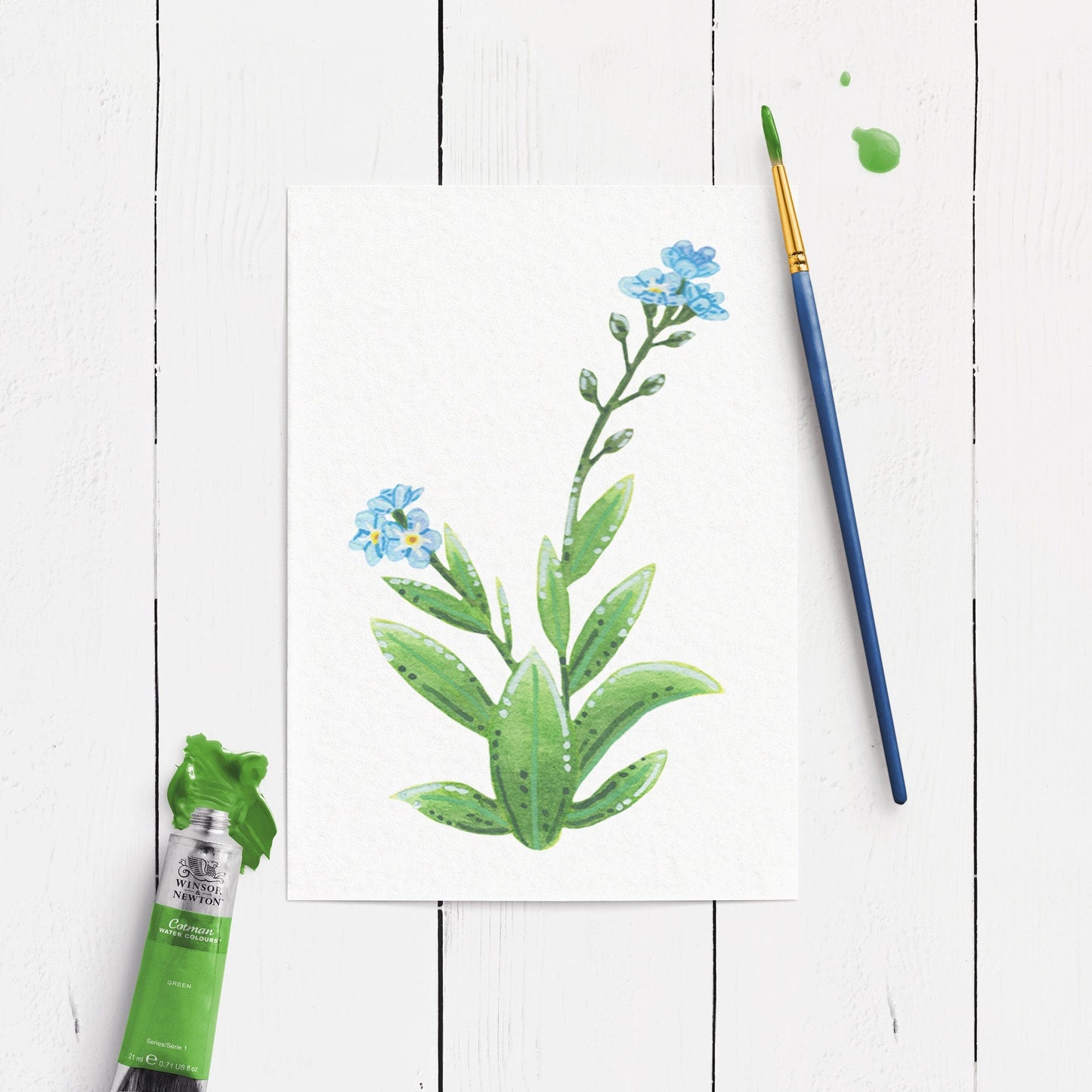 forget me not plant painting. on a white wood table top