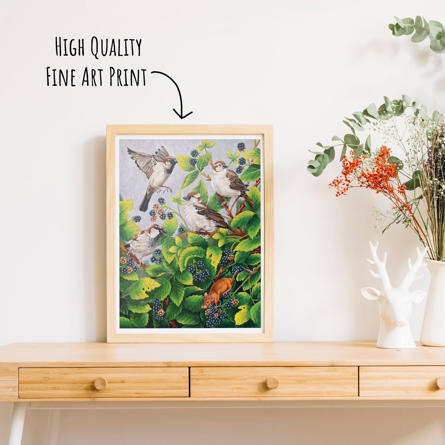 Framed high-quality fine art print of birds on a branch with berries on a wooden surface.