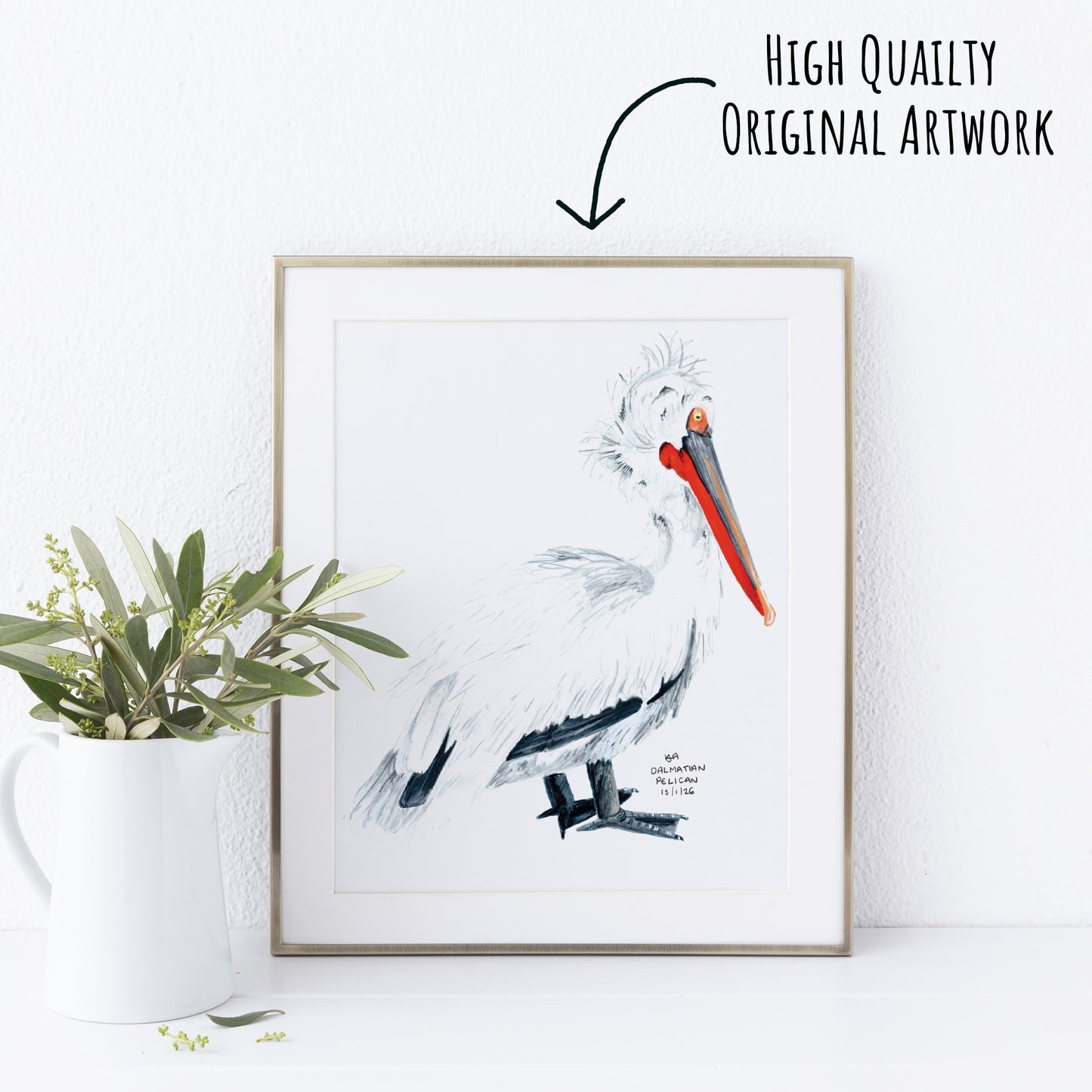 Framed artwork of a dalmatian pelican with a plant on a white wall