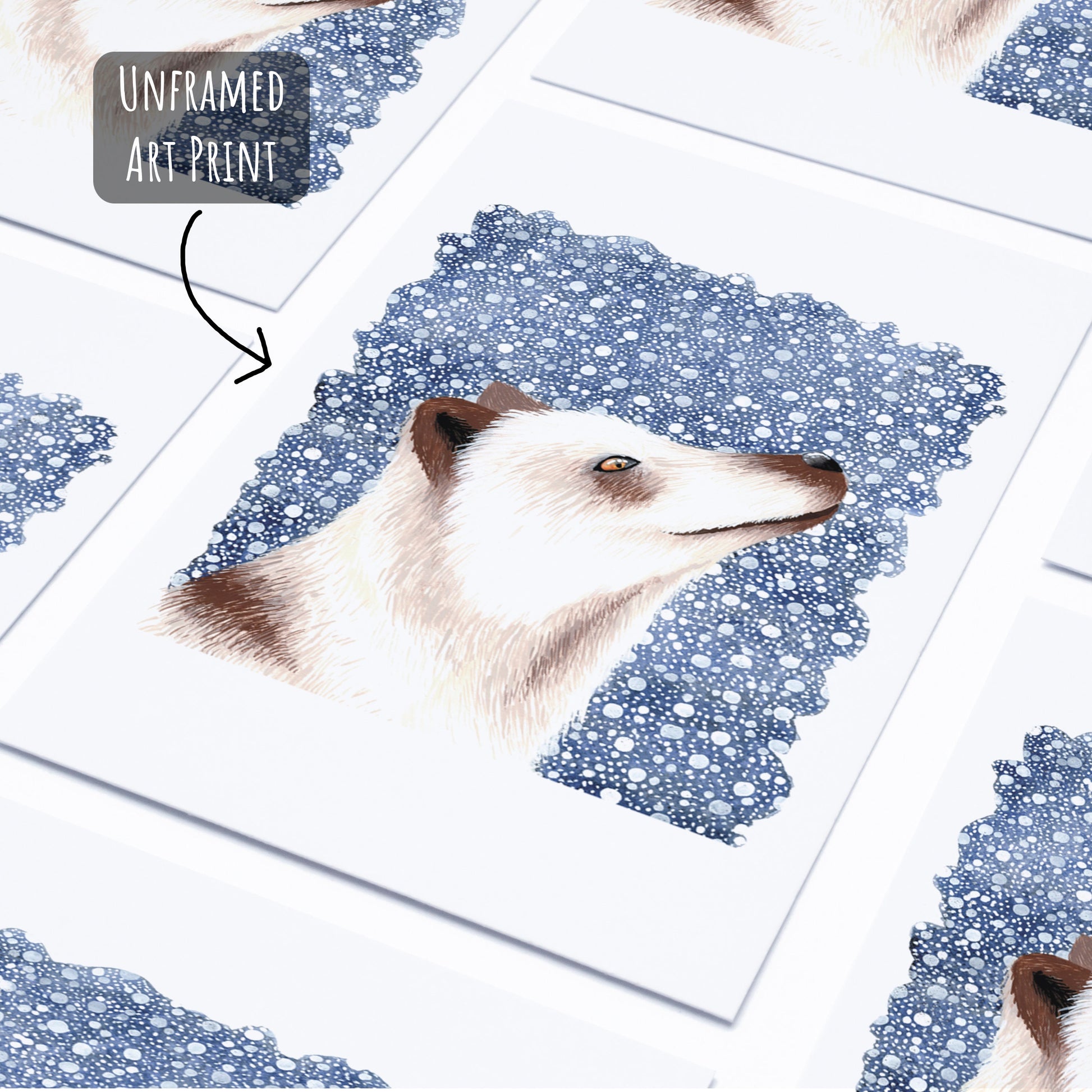 An Arctic fox art print laying flat on a white surface.