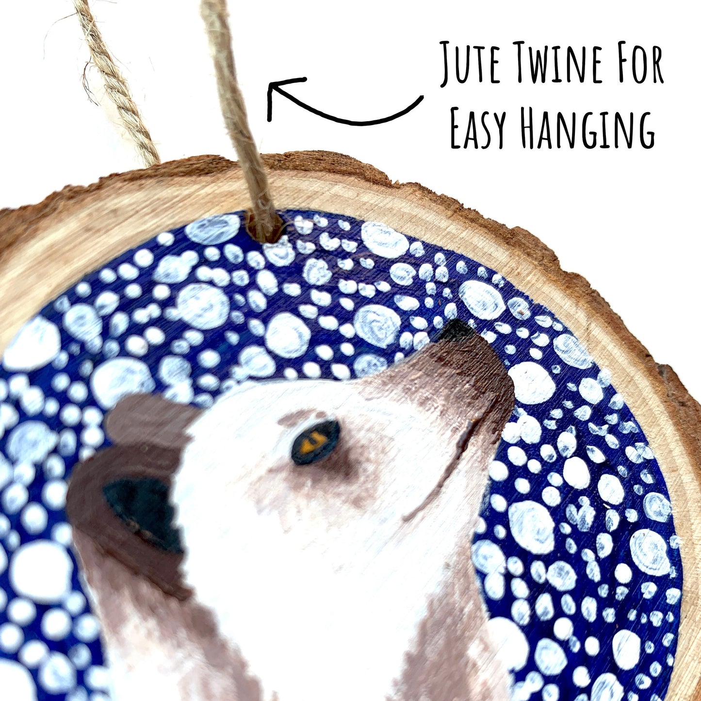 showing a close up the Arctic Fox Wood Slice Ornament showing the details of the painting with the text jute twine for easy hanging.