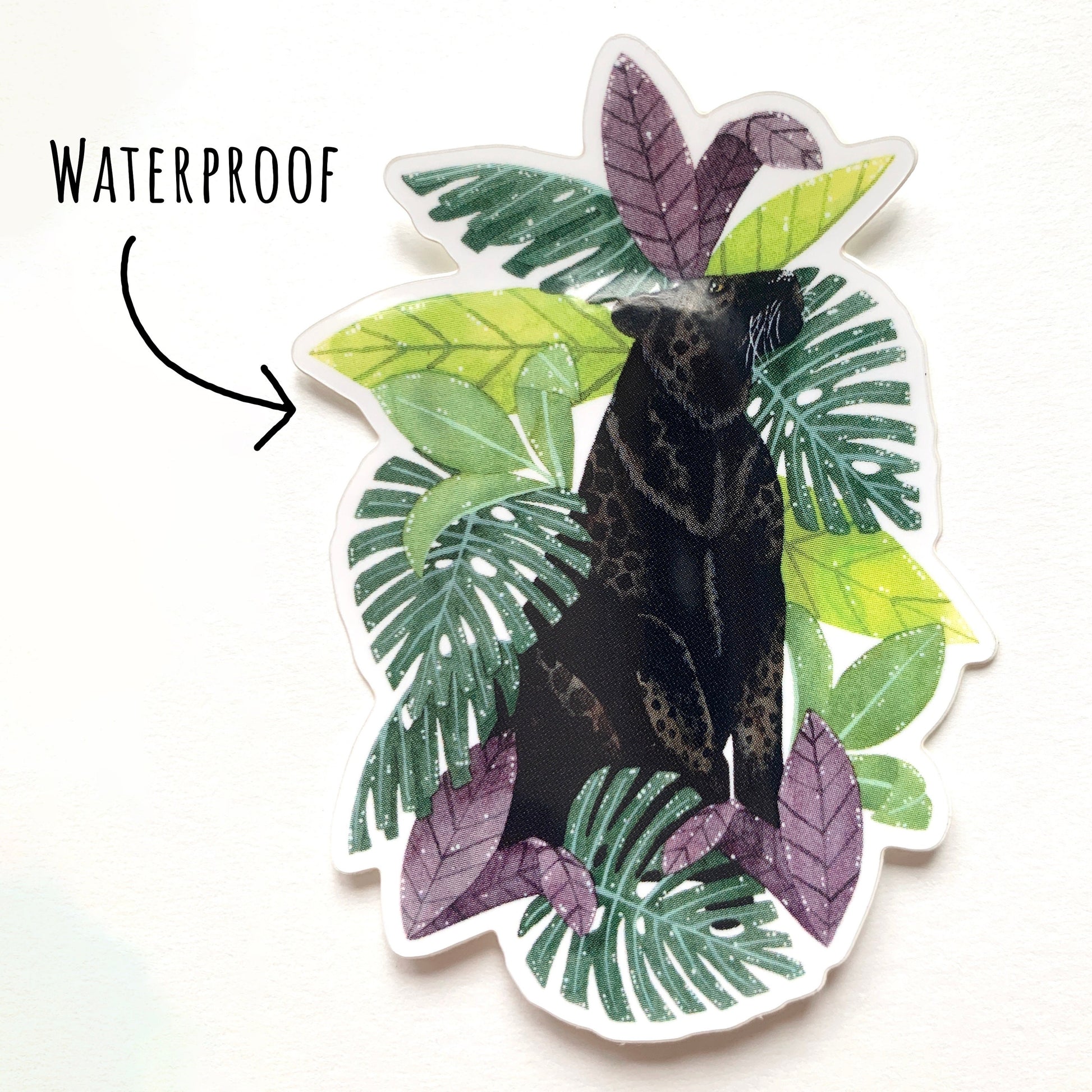 Black Leopard and Tropical Leaves Sticker on a white surface with the text waterproof.