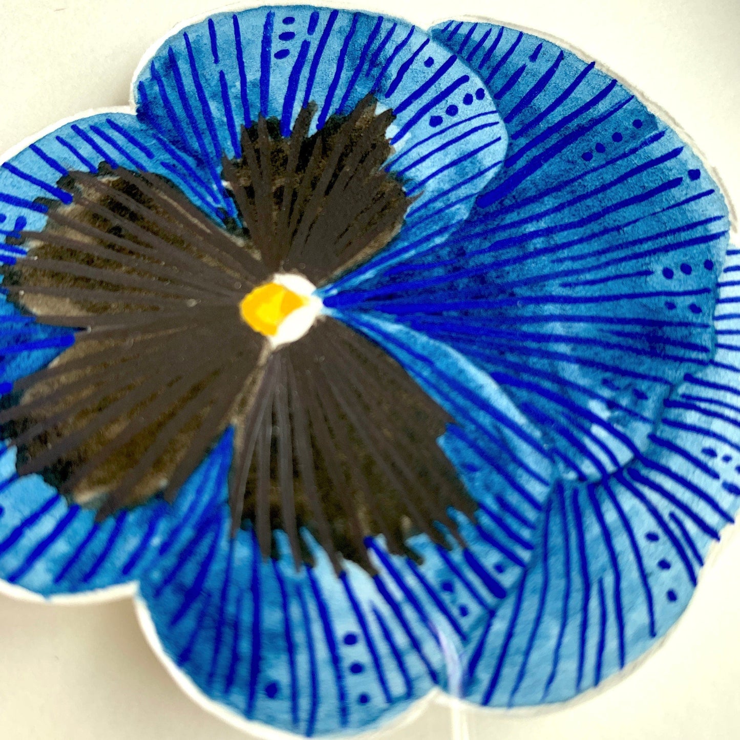 A close up of a blue and black pansy flower head painted in watercolour and gouache