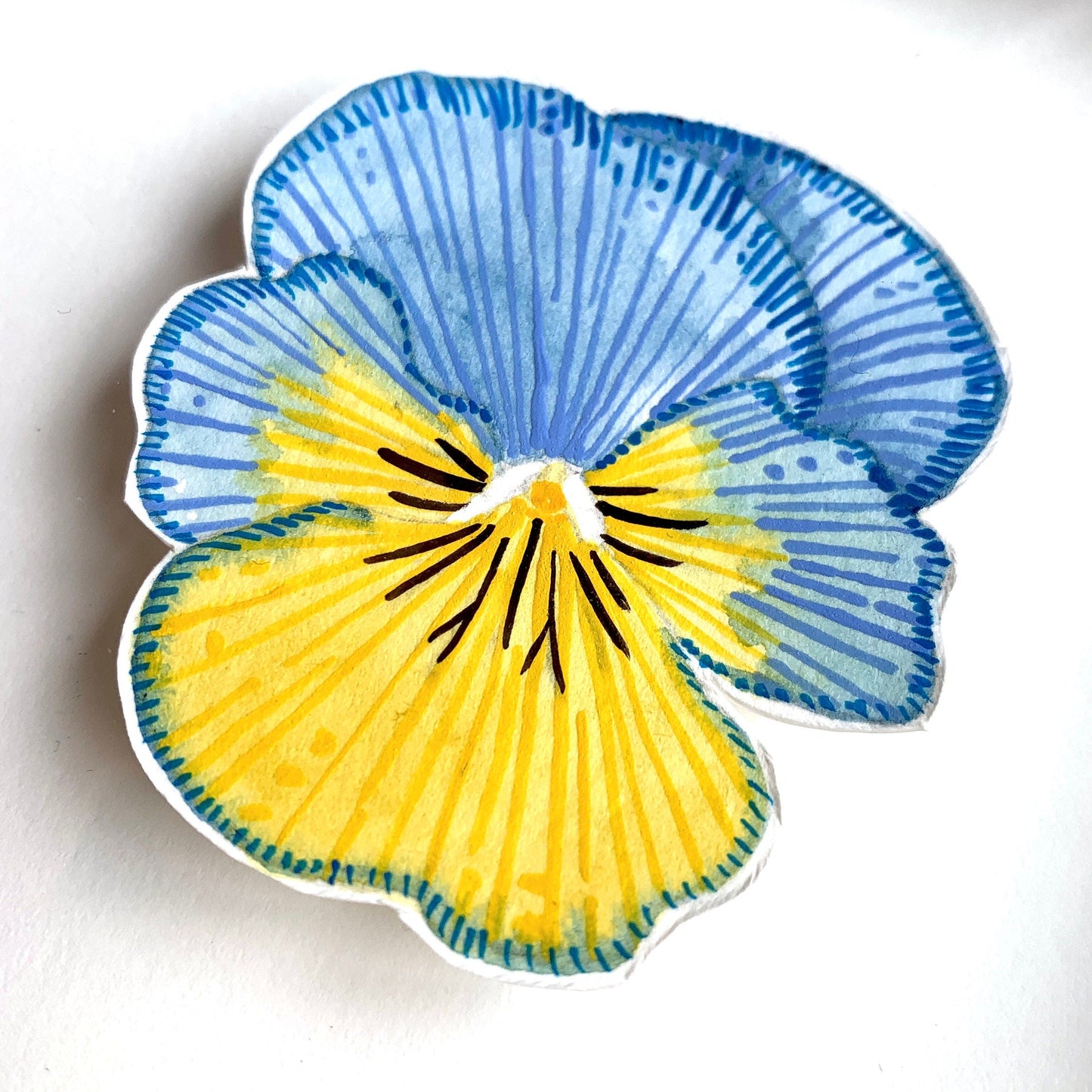 A close up of a painted blue and yellow pansy flower painted in watercolour and gouache