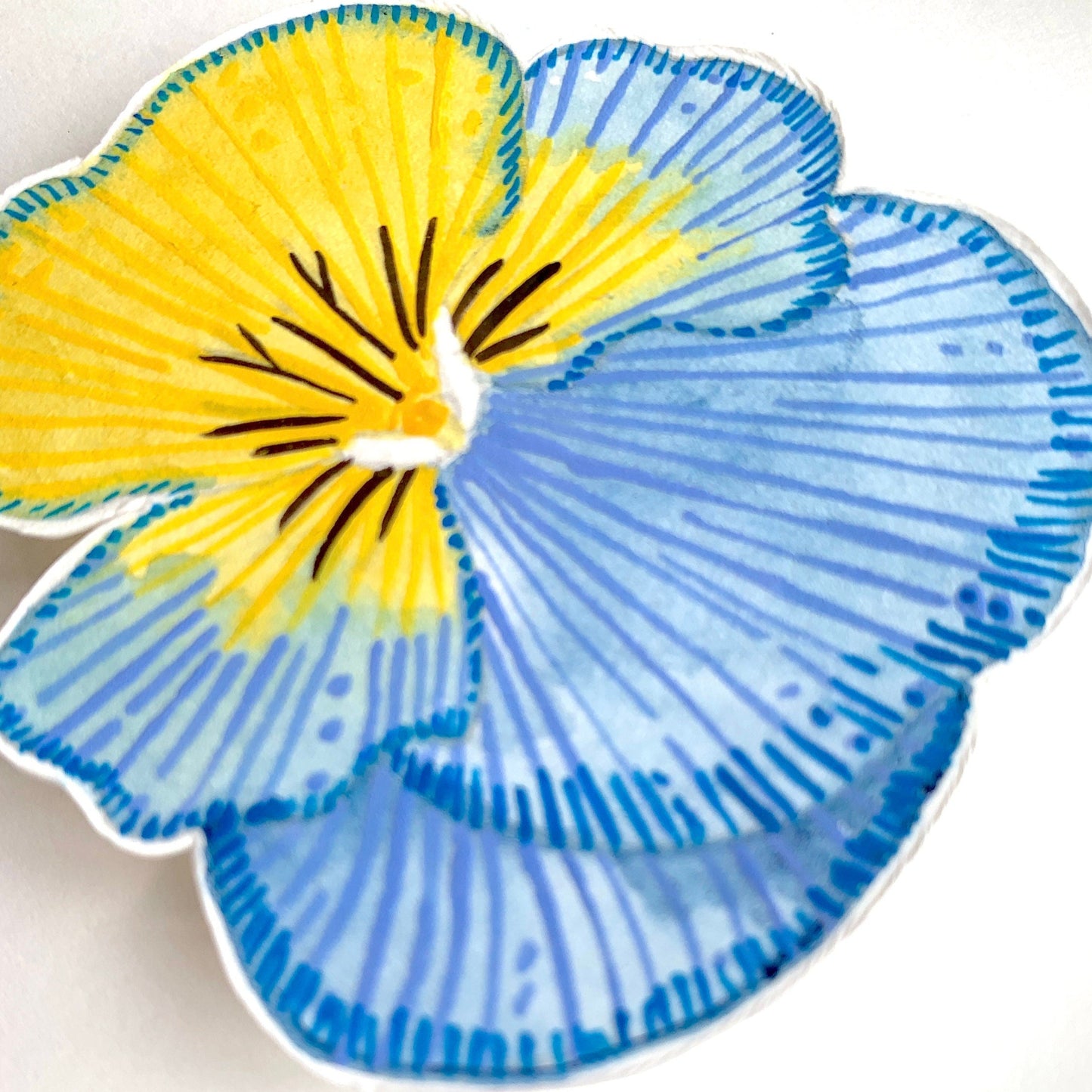 A close up of a painted blue and yellow pansy flower showing the details and texture of the artwork.