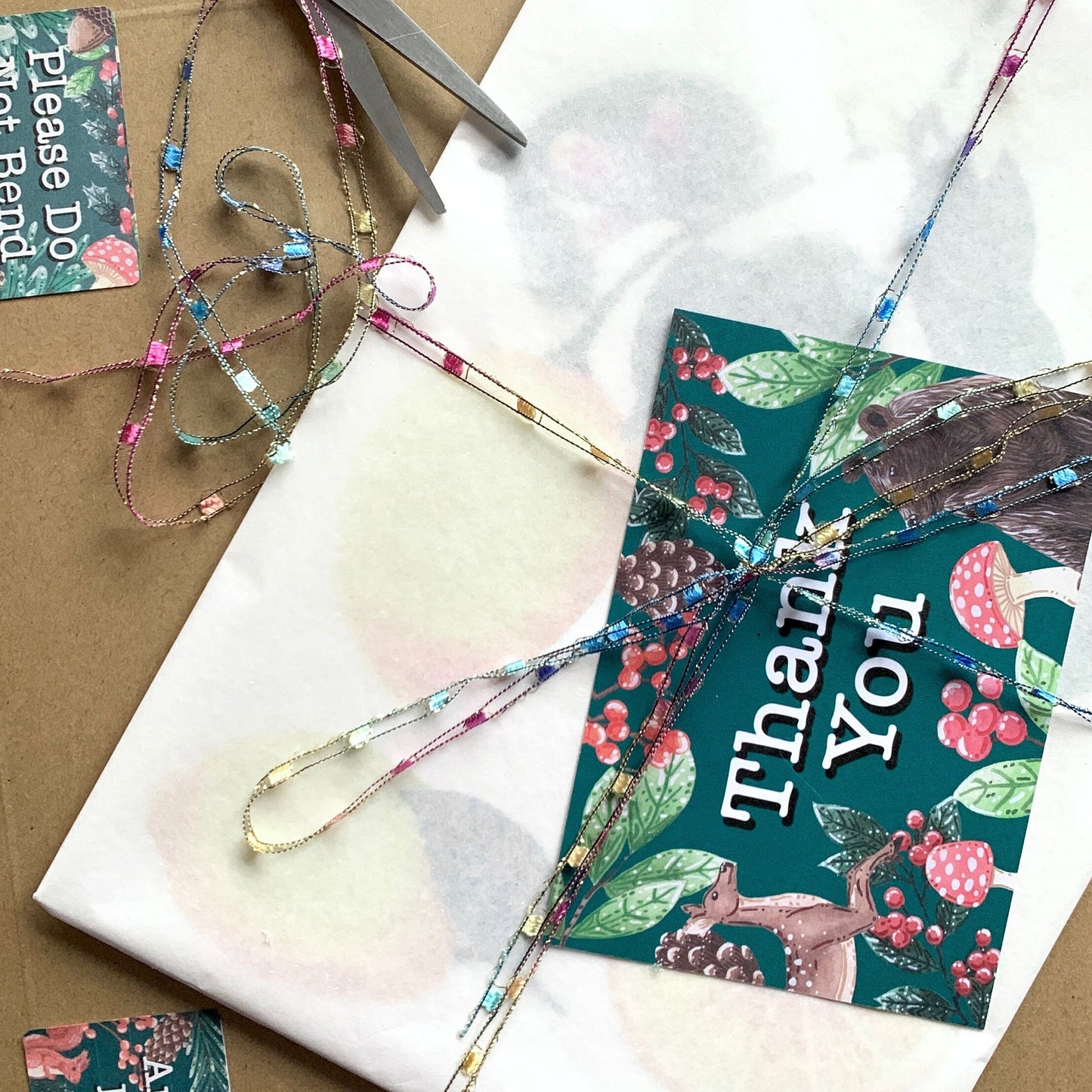 showing the packing of what the artwork is sent in. the artwork is wrapped in tissue with a backing broad then placed in a hard backed envelope with a thank you card