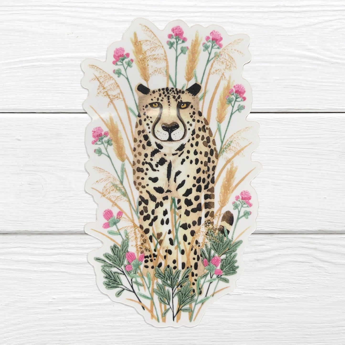 A sticker depicting a cheetah with a background of grasses and flowers.