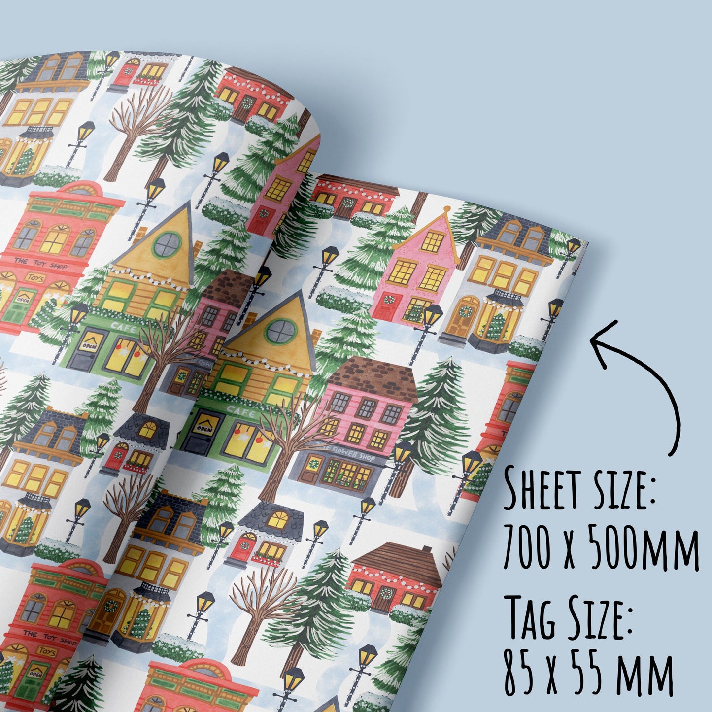 showing the size of the Christmas Village Wrapping Paper sheets and tags with the text sheet size 700 x500m, tag size 55 x 55mm.