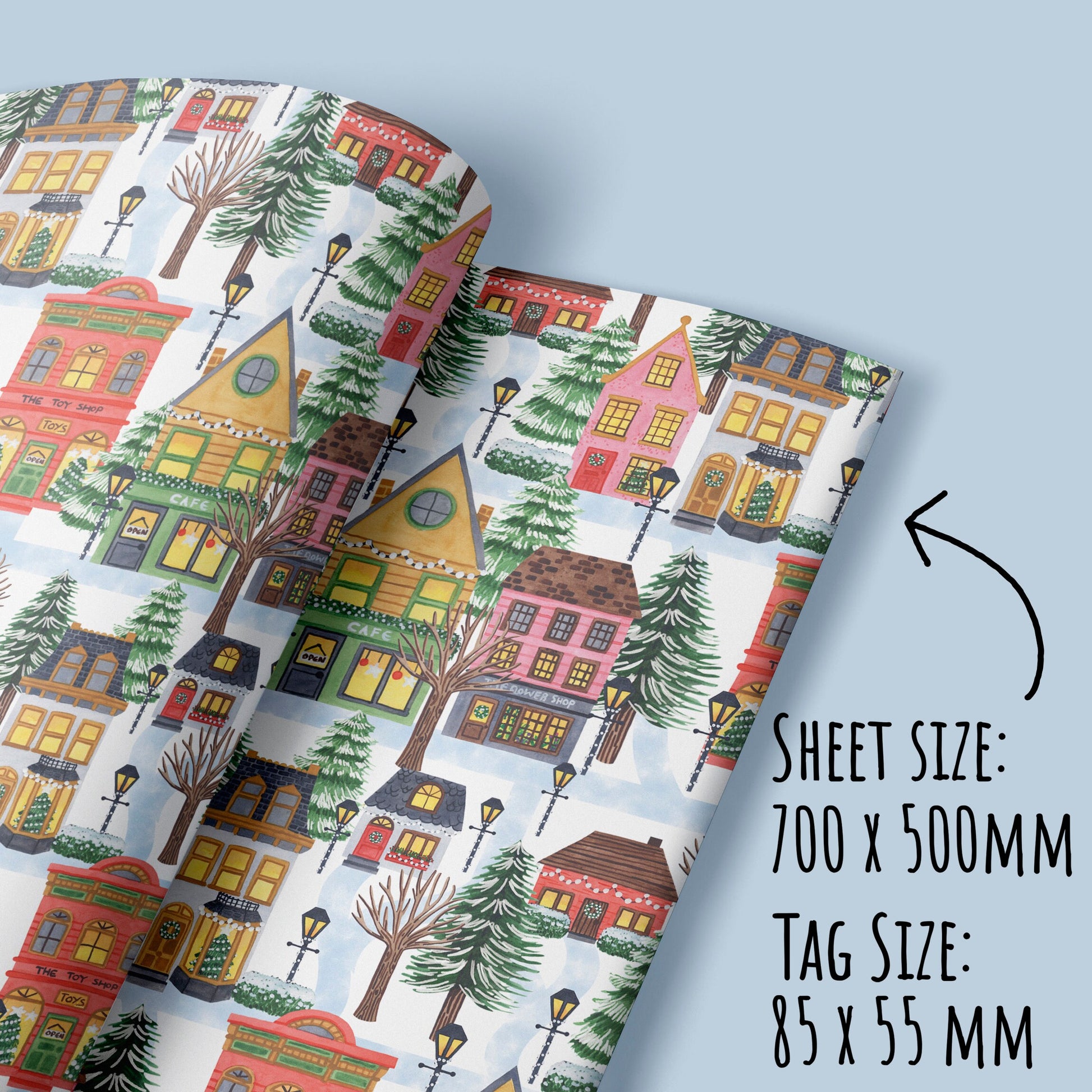showing the size of the Christmas Village Wrapping Paper sheets and tags with the text sheet size 700 x500m, tag size 55 x 55mm.
