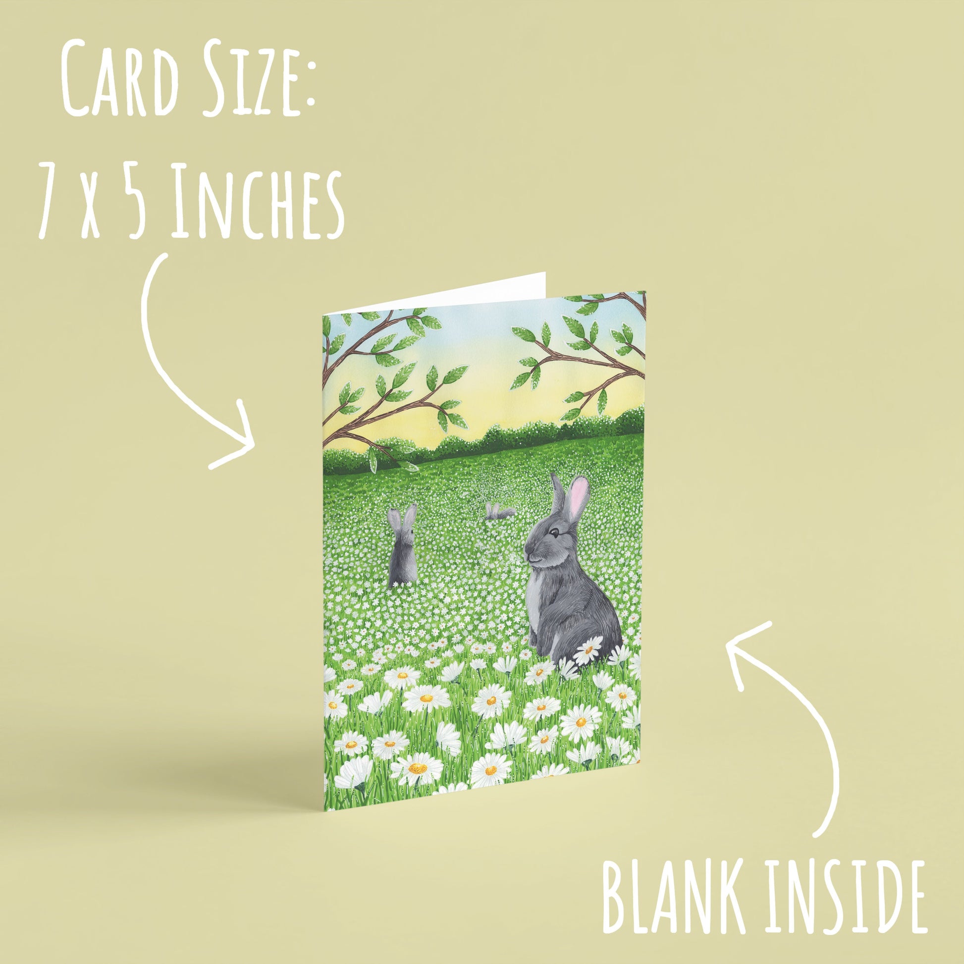 Daisy Meadow Rabbit Birthday Card standing with a pale yellow background with the text: card size: 7 x 5 inches and blank inside.
