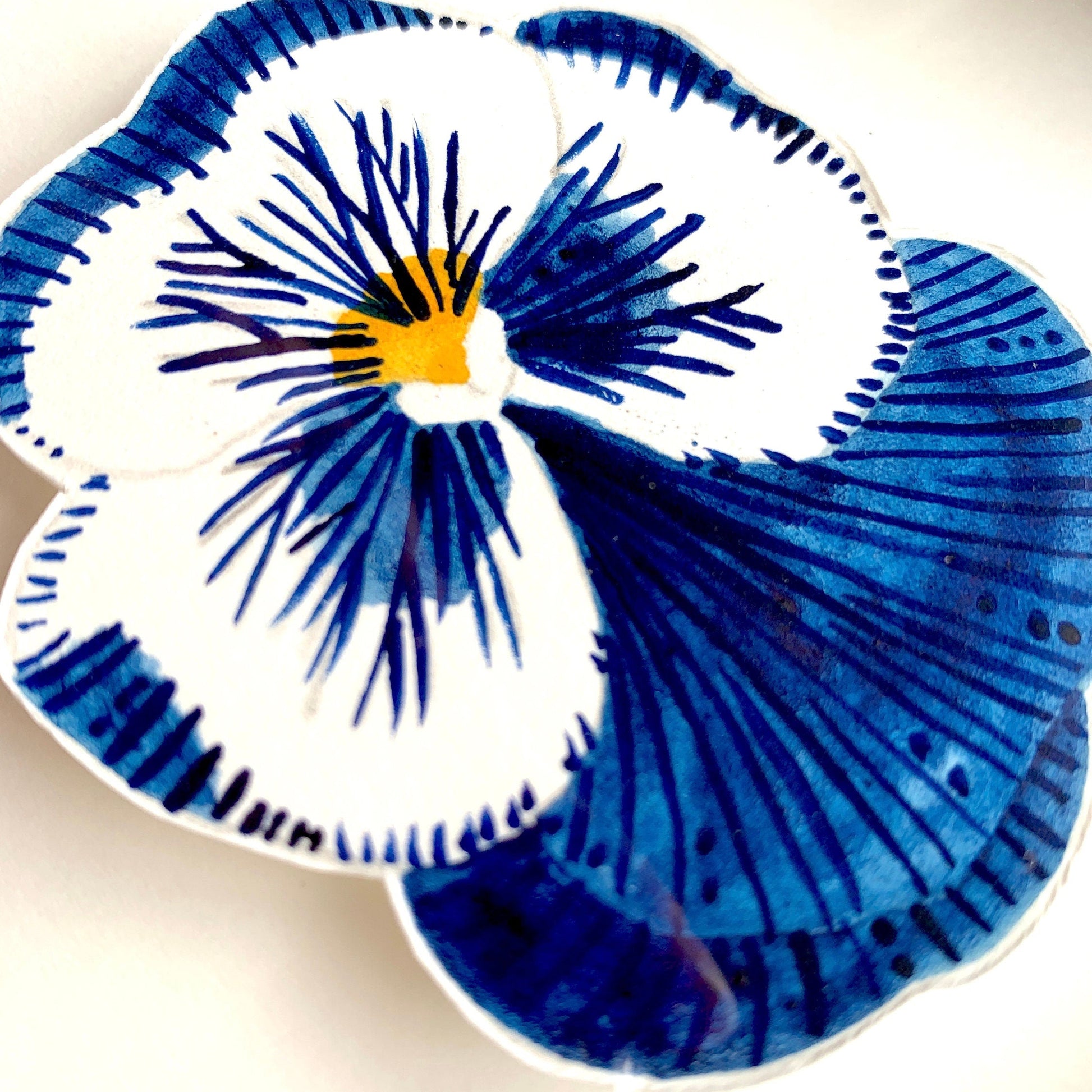 Hand painted blue pansy artwork on smooth paper close up