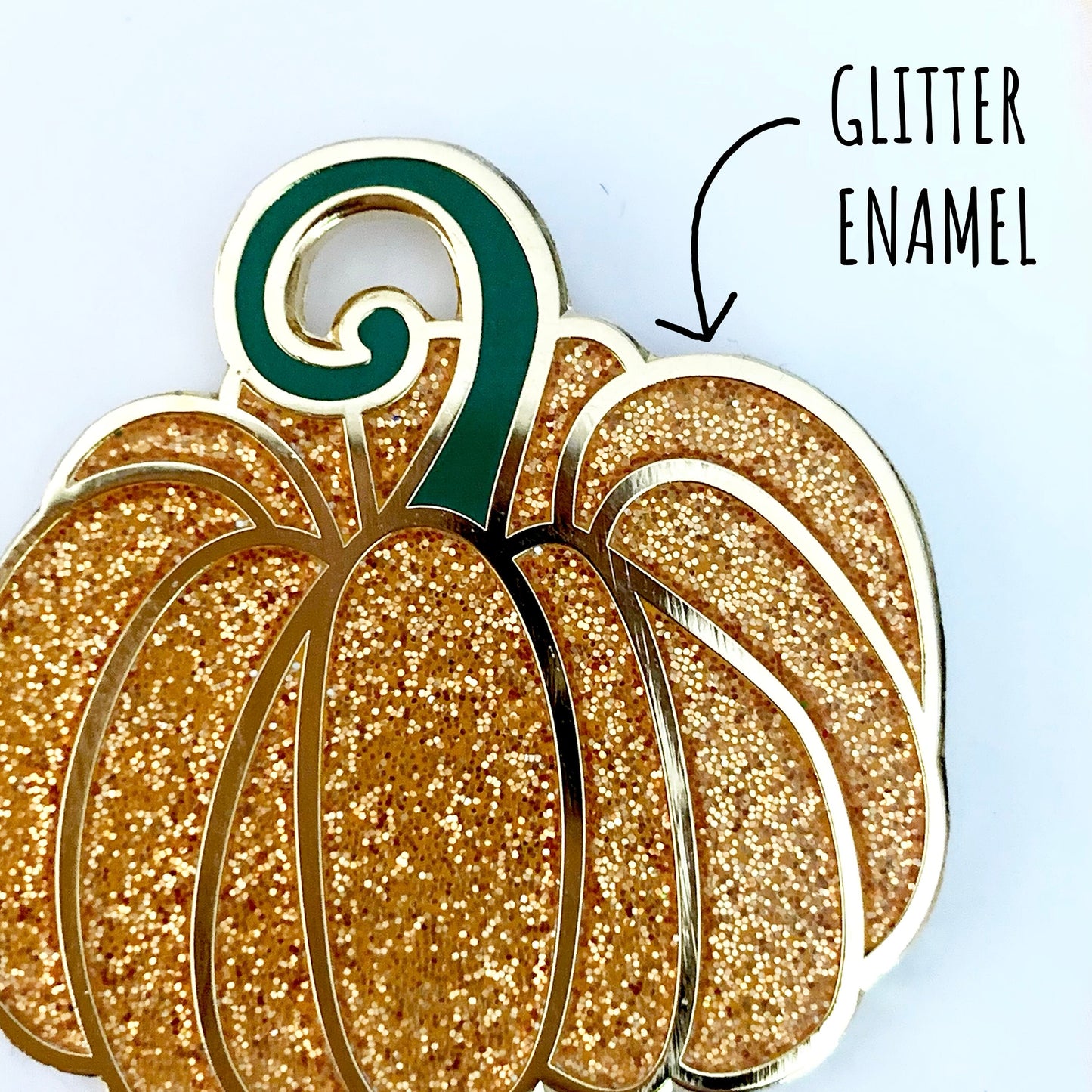 Fairytale Pumpkin Enamel Pin Badge close up showing the glittery orange details and textures and this lovely pin badge. With the texture glitter enamel.