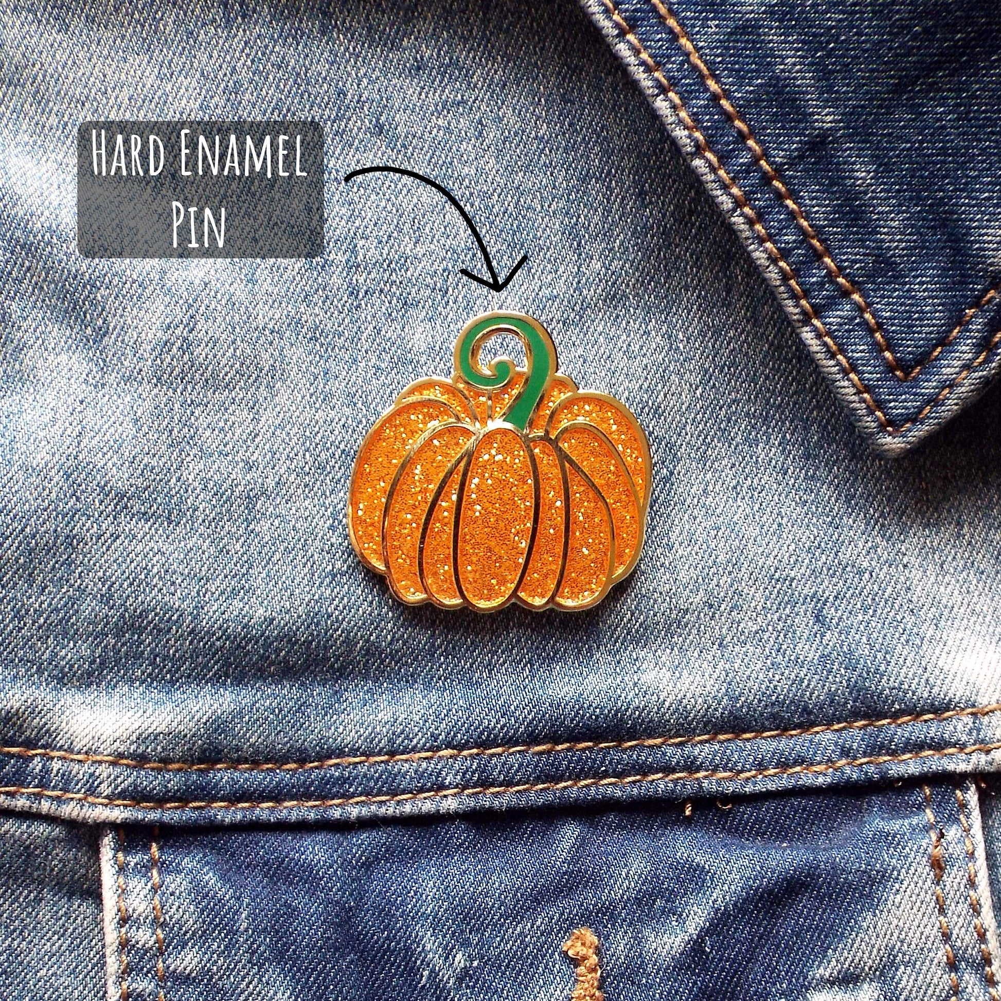 Fairytale Pumpkin Enamel Pin Badge pinned to a blue denim jacket with the text hard enamel pin. 