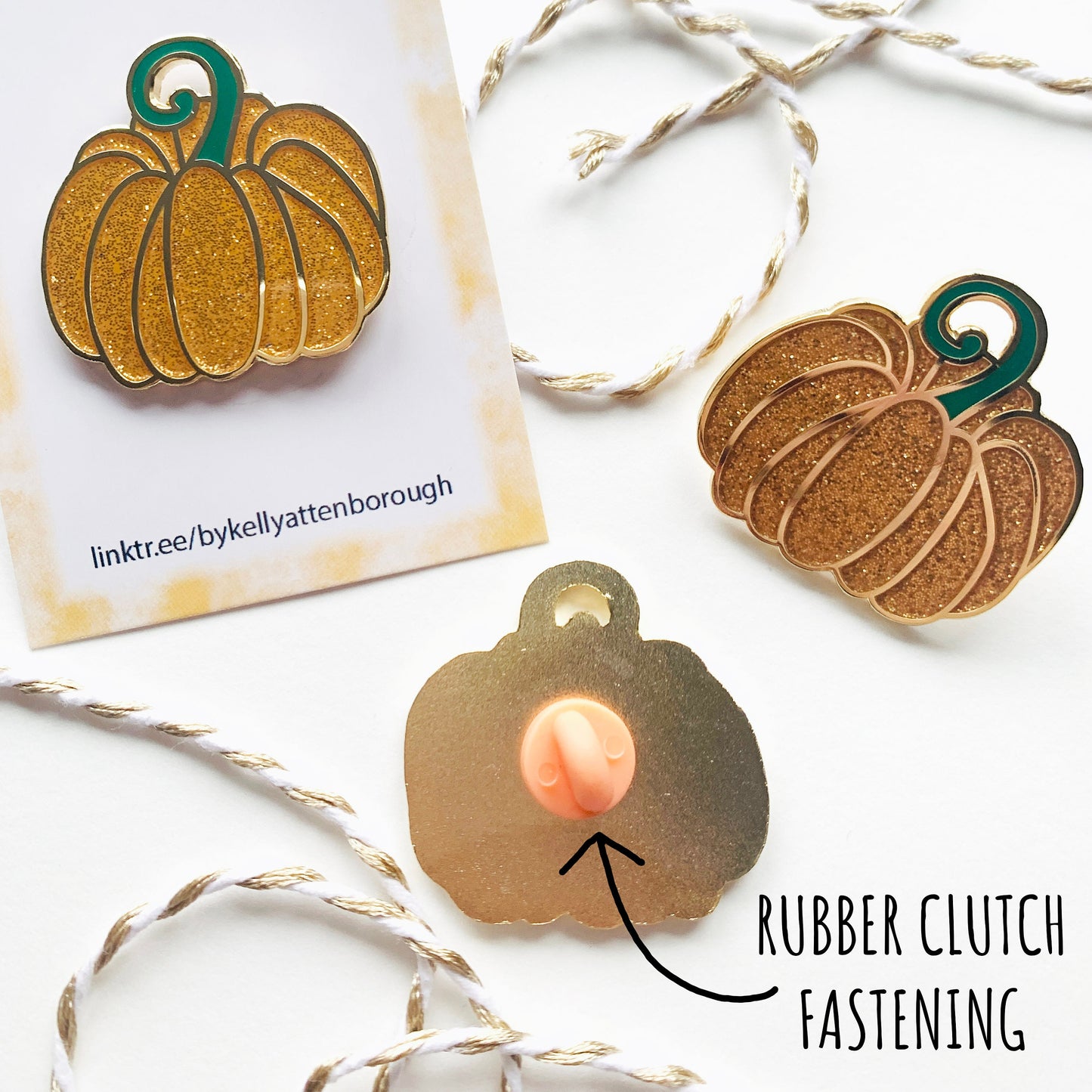 showing three Fairytale Pumpkin Enamel Pin Badges. One on its backing card one without and the third one showing the back with its orange rubber clutch fastening. with the text rubber clutch fastening.