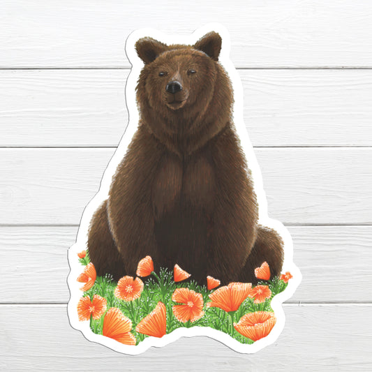 A sticker depicting a brown grizzly bear sitting with Californian orange poppies in the background.