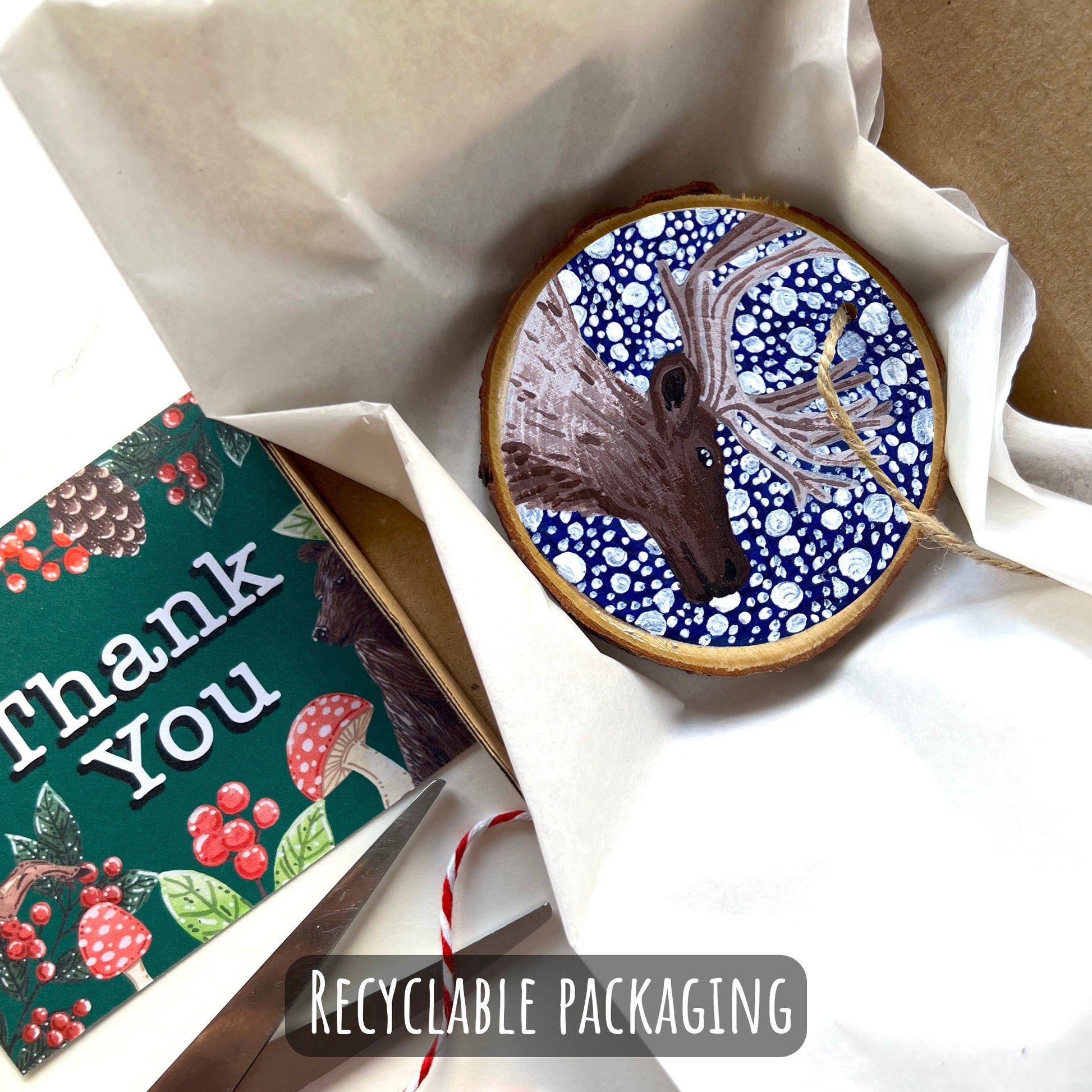 showing how your ornament with be packaged up. wrapped in tissue paper then placed into a box with a thank you card.