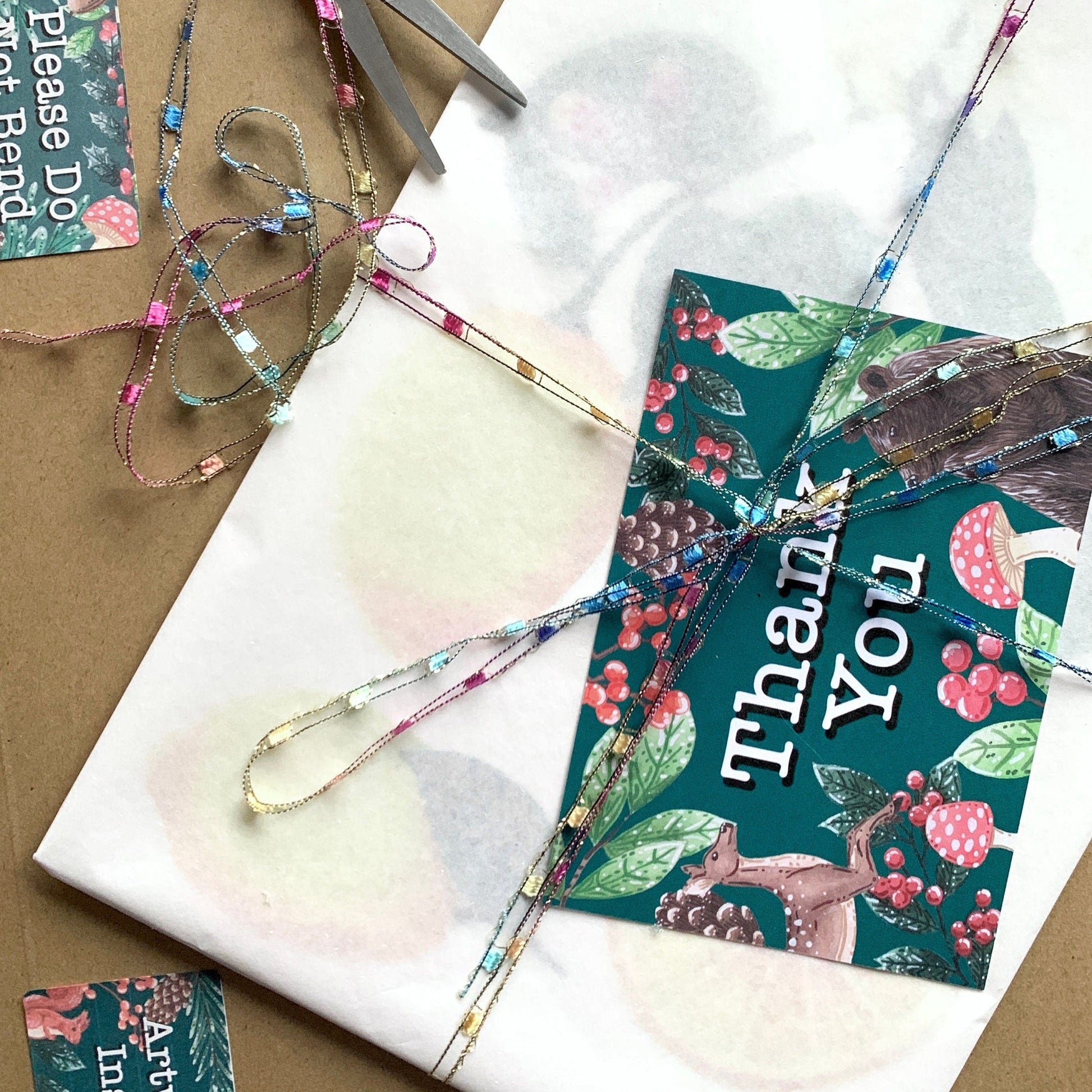 packaging of artwork/prints, wrapped in tissue paper with a backing board and placed into a hard backed envelope.