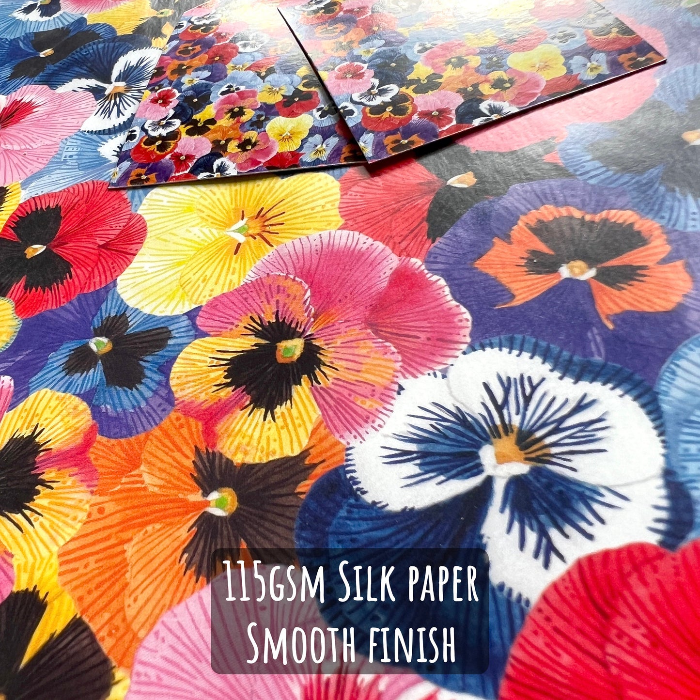 Pansy Flower Wrapping Paper close up showing the details and textures of the illustrations and paper stock. With the text 115gsm silk paper smooth finish.