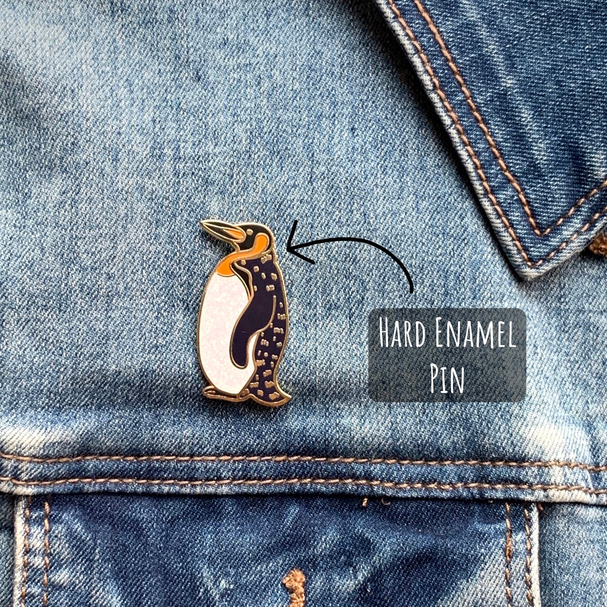 Penguin Enamel Pin Badge pinned to a blue denim jacket with the text hard enamel pin.