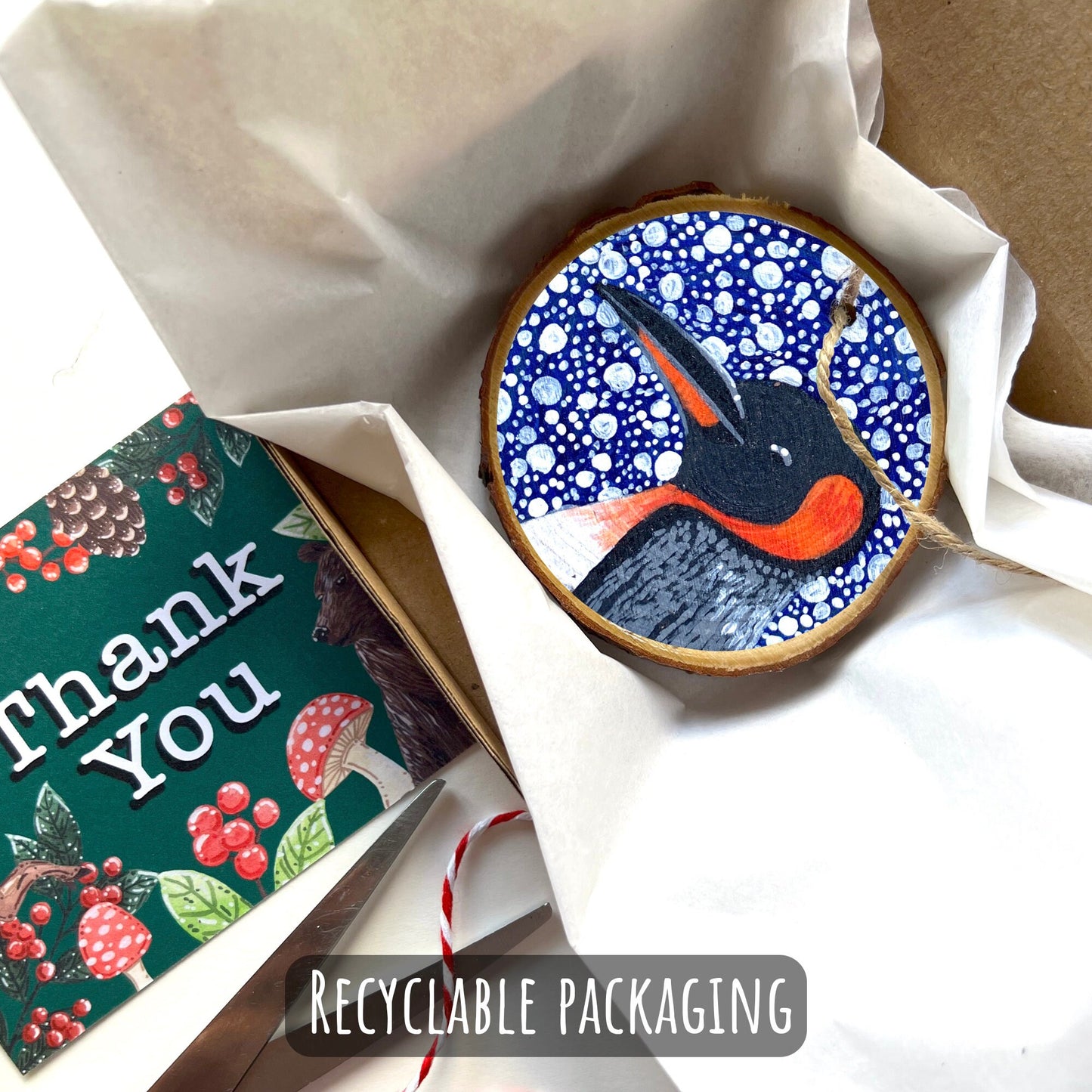 showing how your ornament with be packaged. wrapped in tissue then placed into a box with a thank you card.