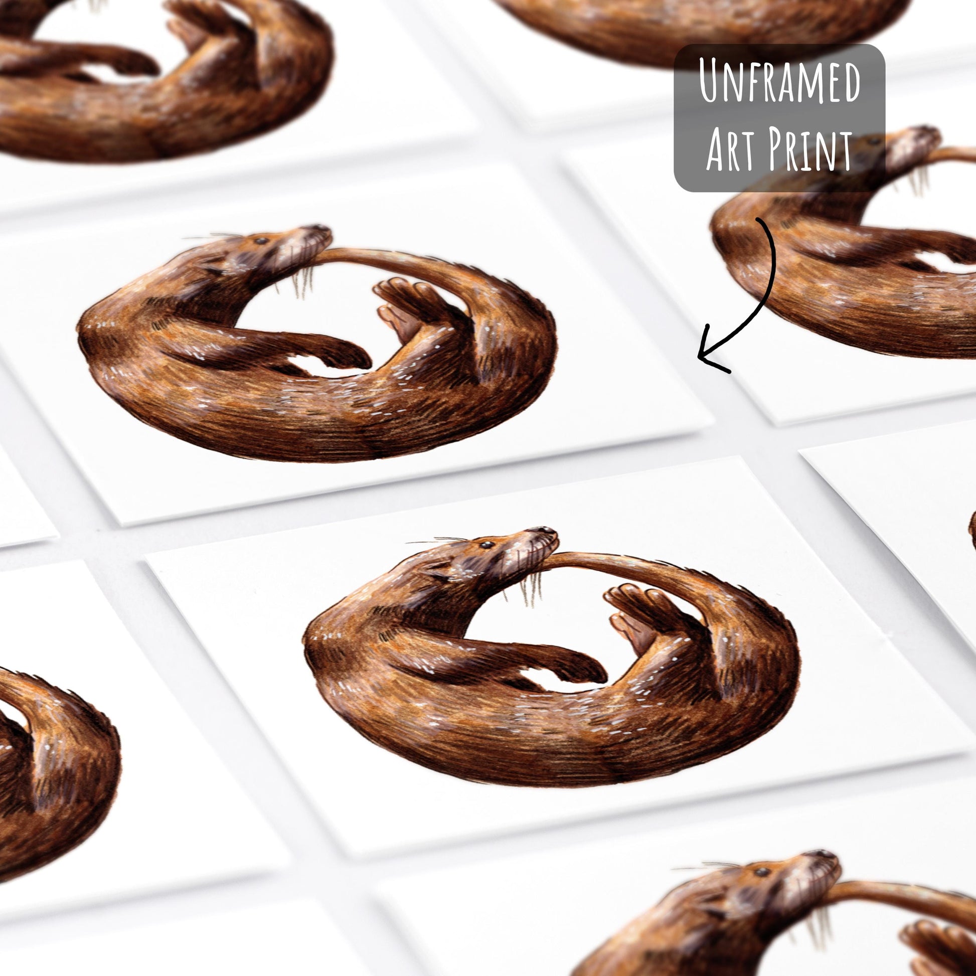Playful Otter Art Print laying flat on a white surface.