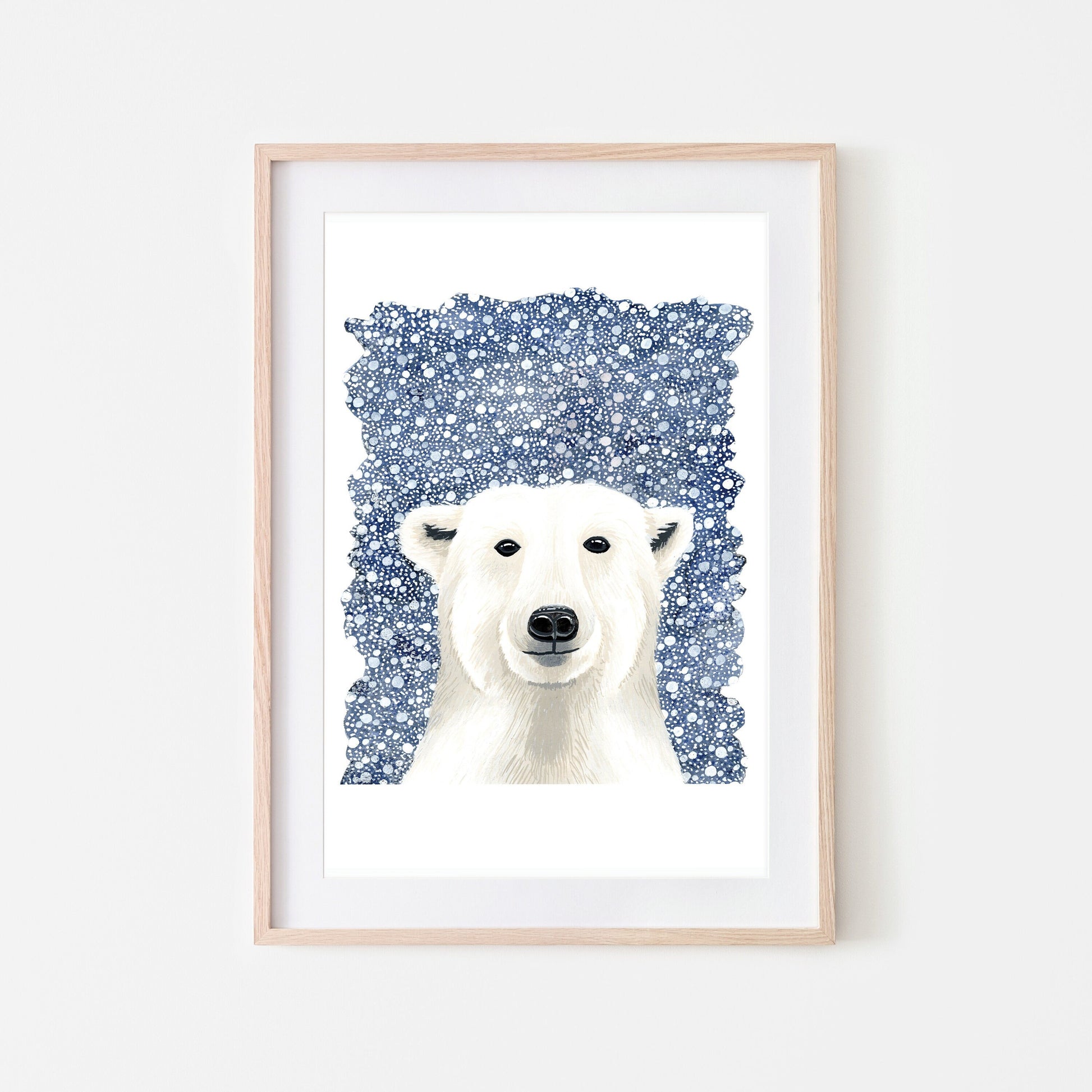 A framed art print of a white polar bear on a dark blue snowy background, with a white border around the illustration.