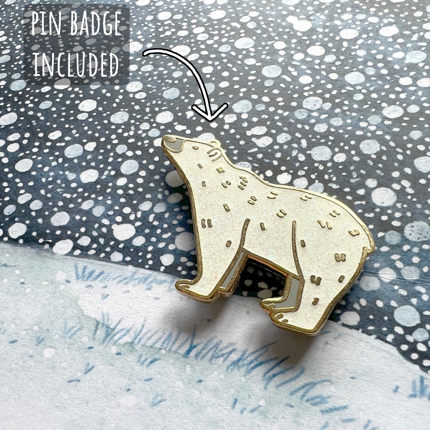 Gold pated white glitter polar bear pin badge on a textured surface of the card with text indicating 'Pin Badge Included' and '300GSM Smooth Finish'.