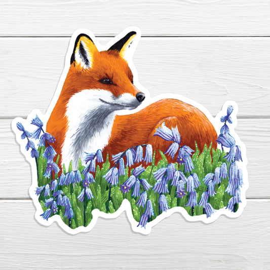A sticker depicting a red fox sitting amidst bluebell flowers.