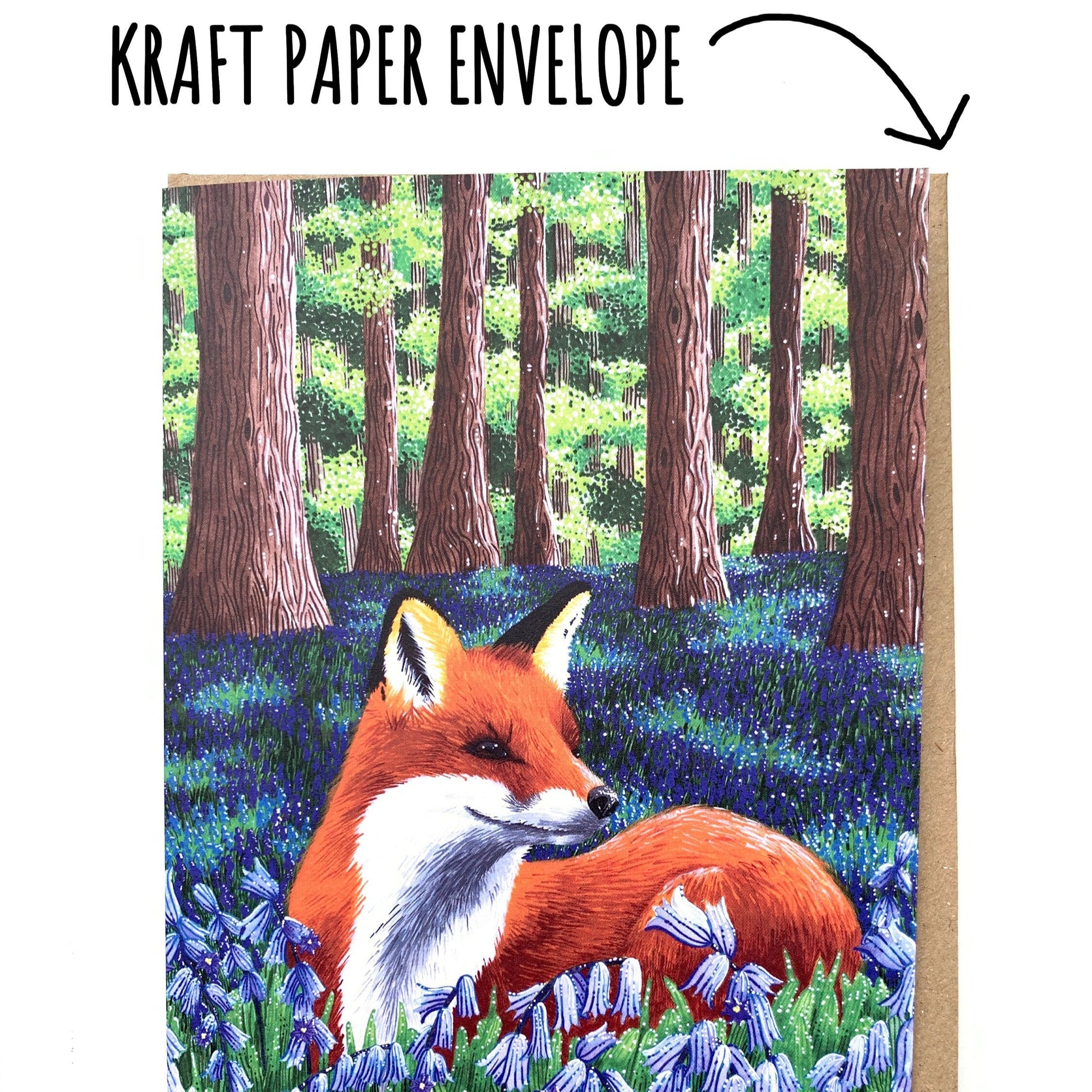 Red Fox with bluebells Birthday Card showing the kraft envelope envelope of a white background. 