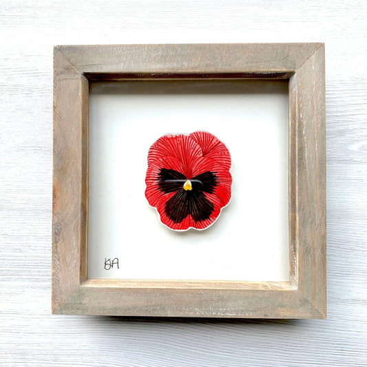 A hand-painted red and black pansy flower watercolour painting in a rustic washed effect box frame.