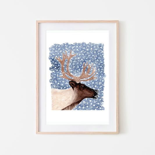 A framed art print of a reindeer with a dark blue snowy background.