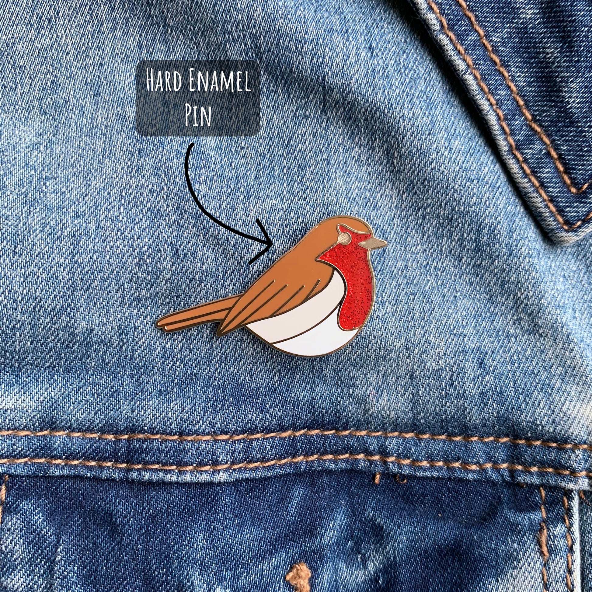 Robin Enamel Pin Badge pinned to a blue denim jacket with the text hard enamel pin.