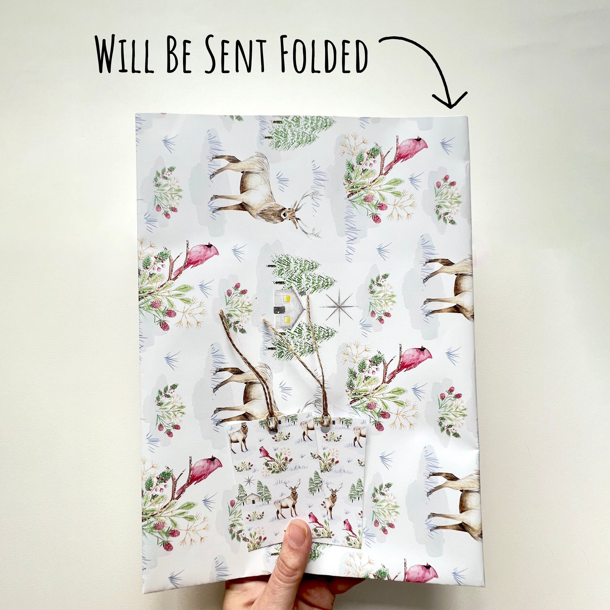 Snowy Winter Scene Wrapping Paper folded which is how the wrapping paper will be sent. with the text will be sent folded.
