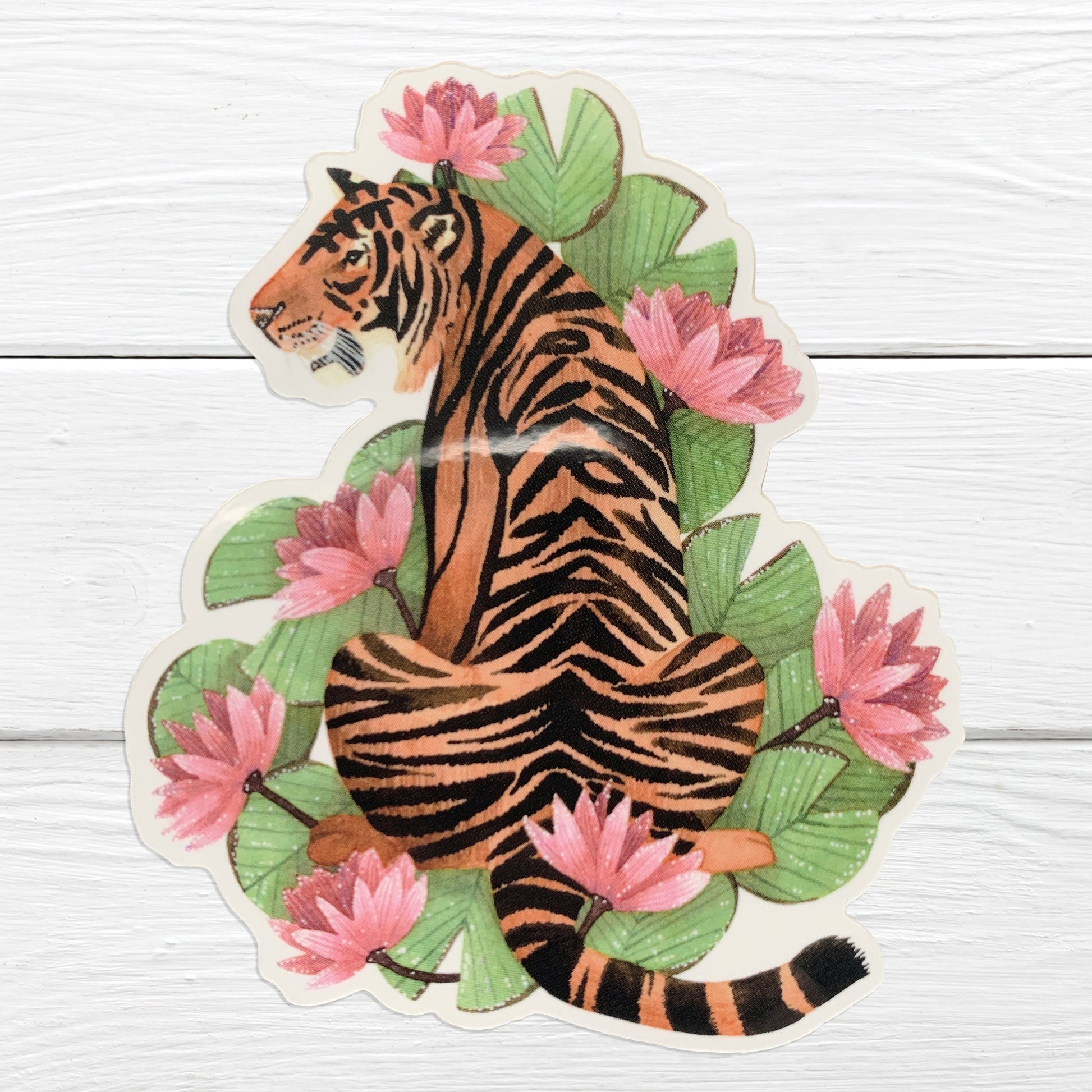 A vibrant sticker depicting a tiger with pink lilies and green lily pads in the background.