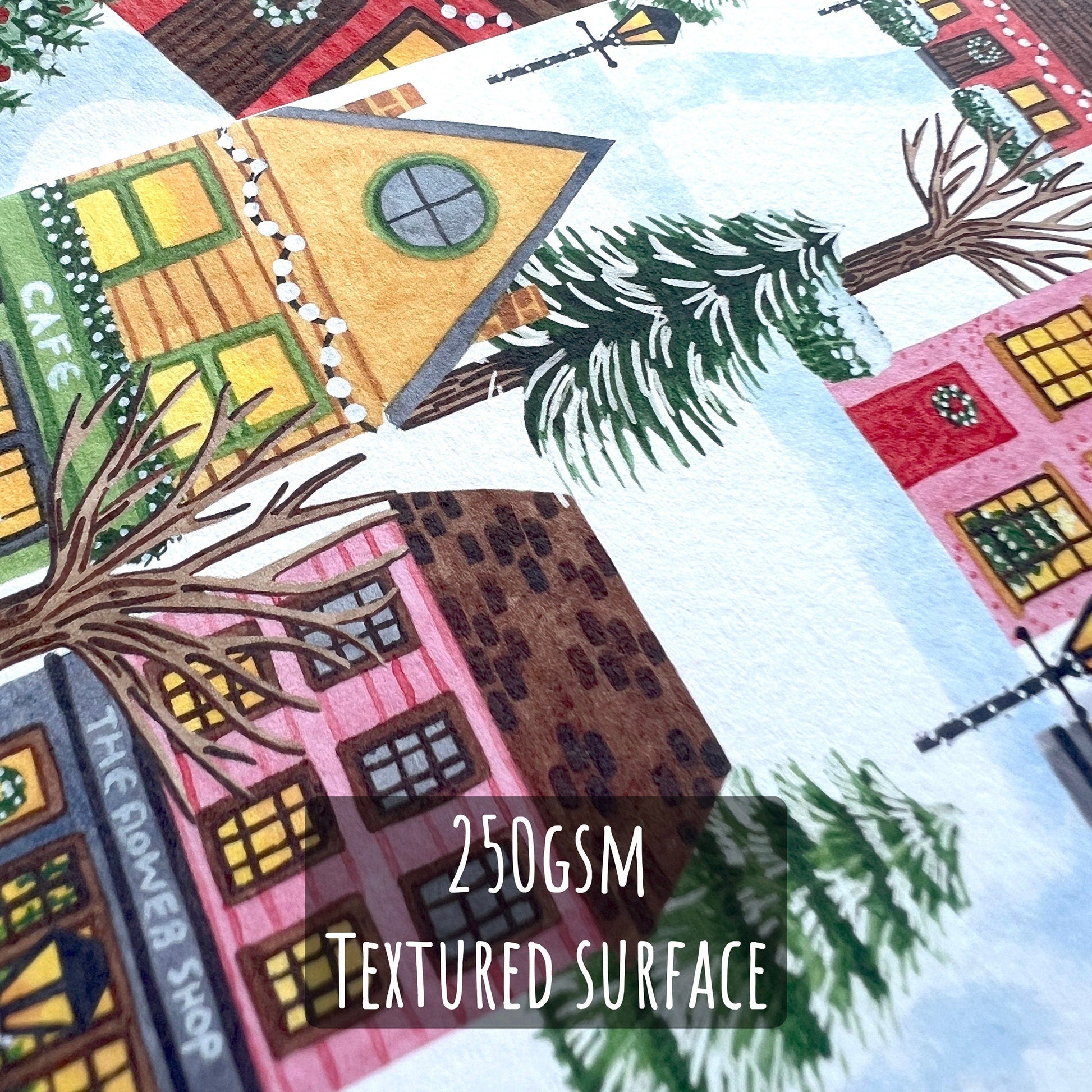 A close up of one of the Village & Lodge luxury Christmas Cards showing the details and texture of the illustration and paper stock. featuring the text 250gsm textured surface.