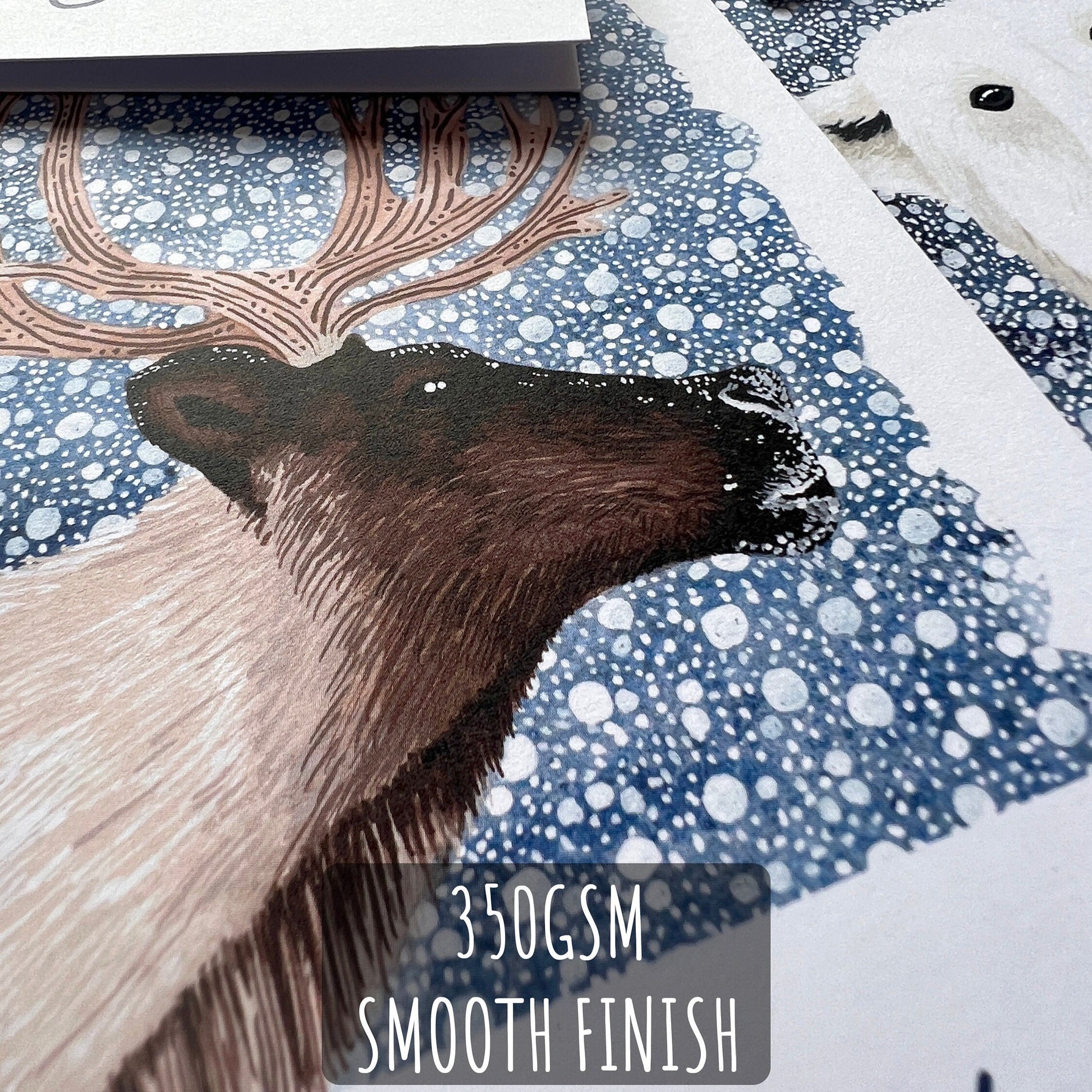 A close up of one of the Winter Animal Christmas Cards showing the details and textures of the illustration and paper stock. with Text: 350gsm smooth finish.