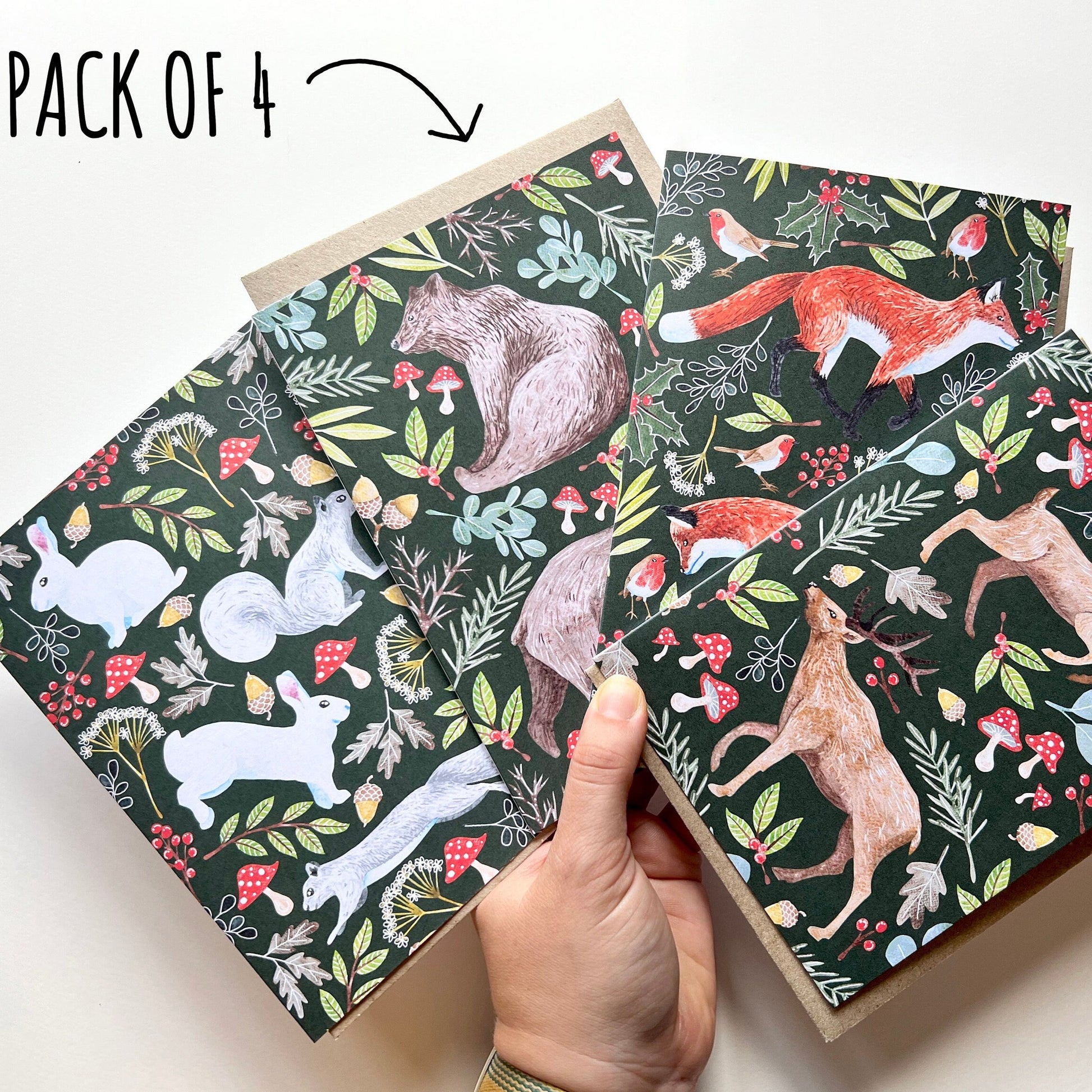 Pack of four notebooks with animal patterns on a white background