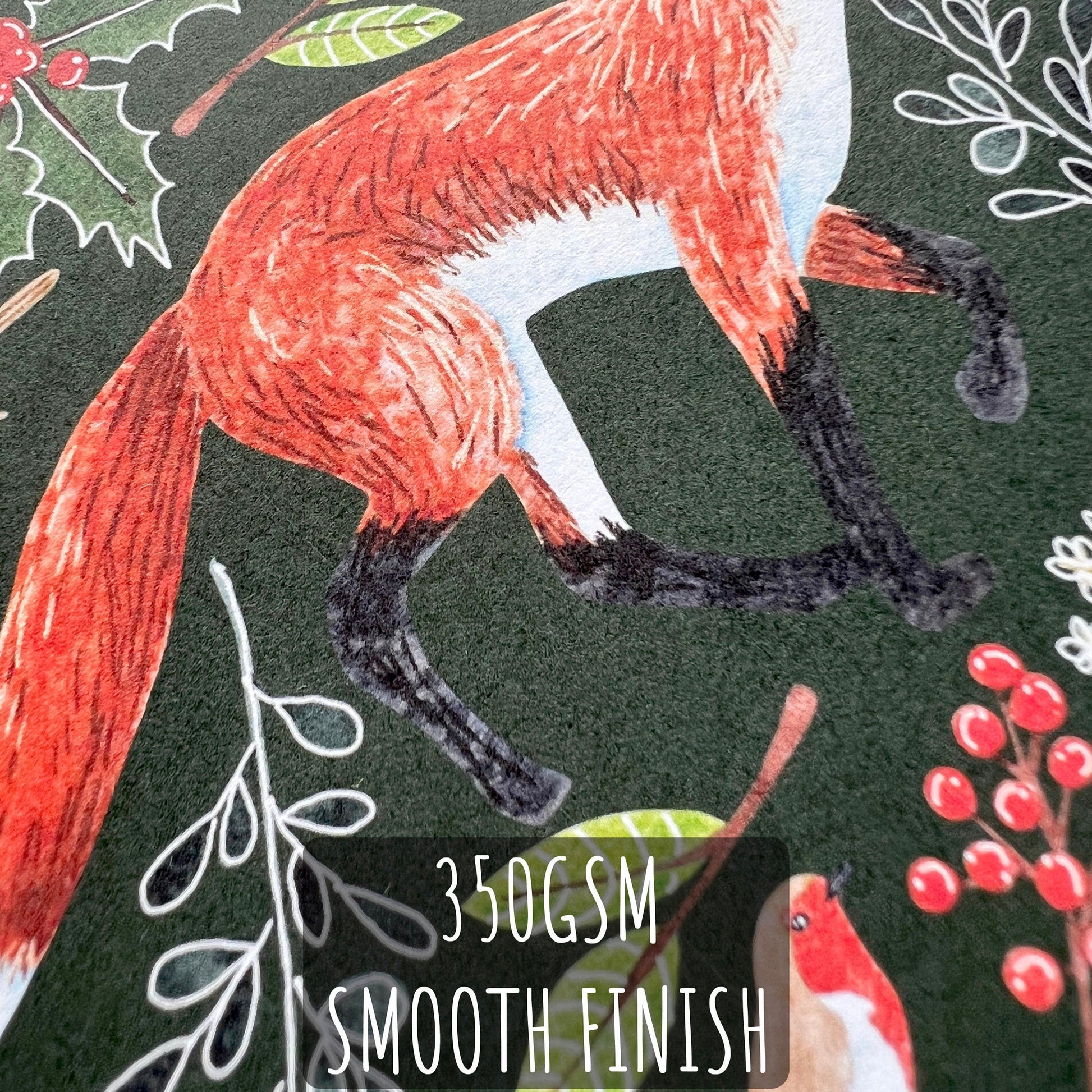 A close up of one of the Woodland Animal Christmas cards showing the details and textures of the illustration and the paper stock. with the text 350gsm smooth finish.