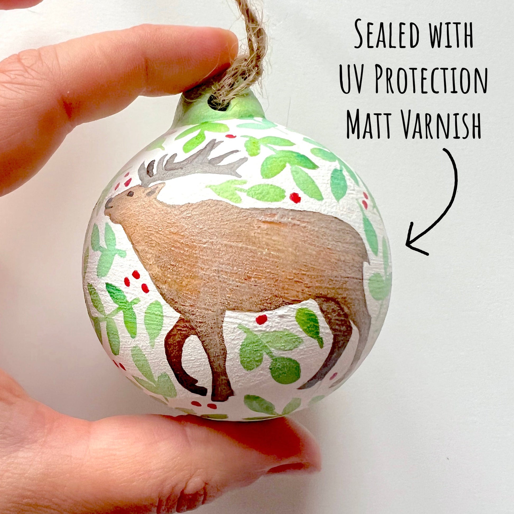 showing the deer of the Woodland Animals Ceramic Baubles on a white background with the text sealed with uv protection matt varnish.