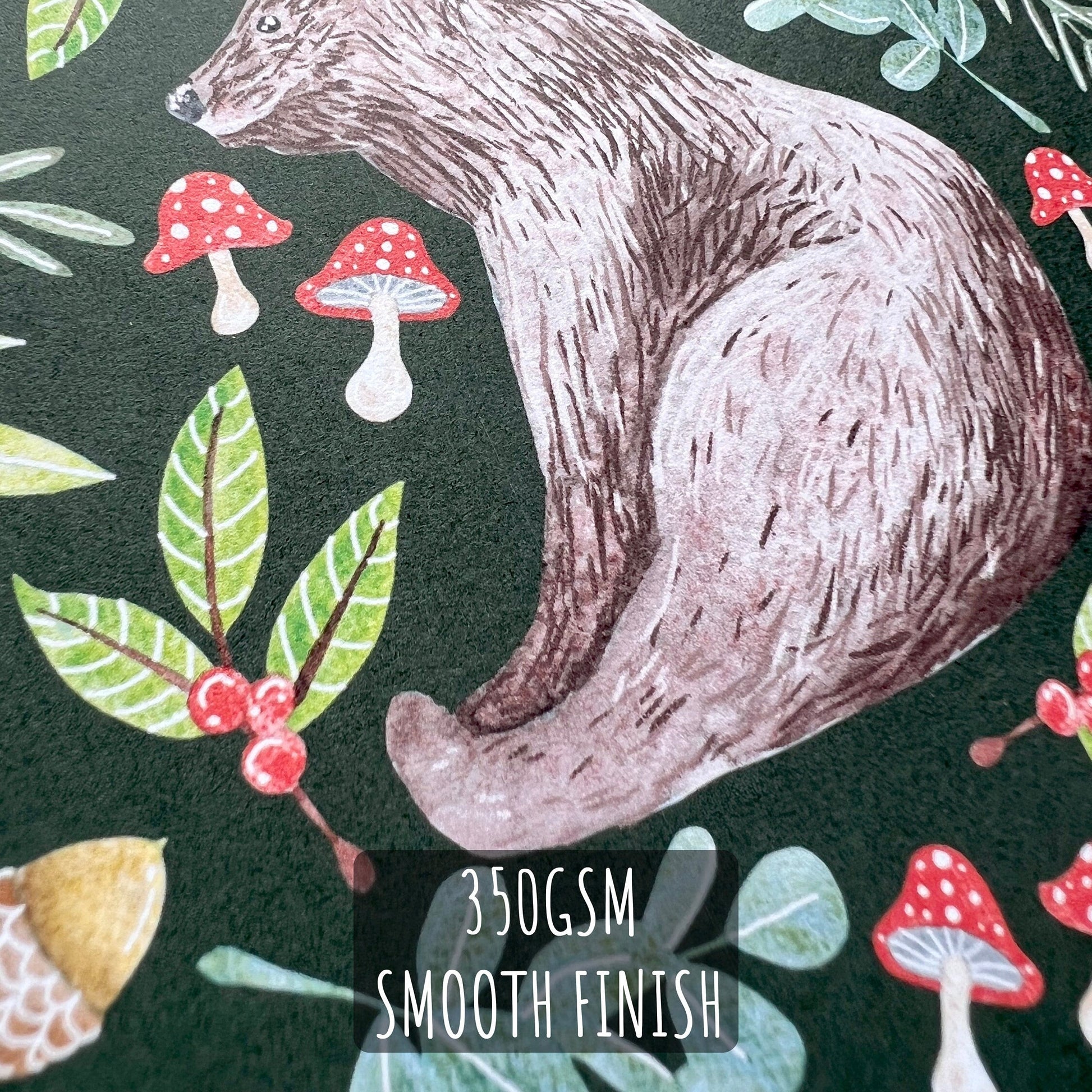 Woodland Bear Christmas Card close up showing the details of the illustration and paper stock. with text 350gsm smooth finish.