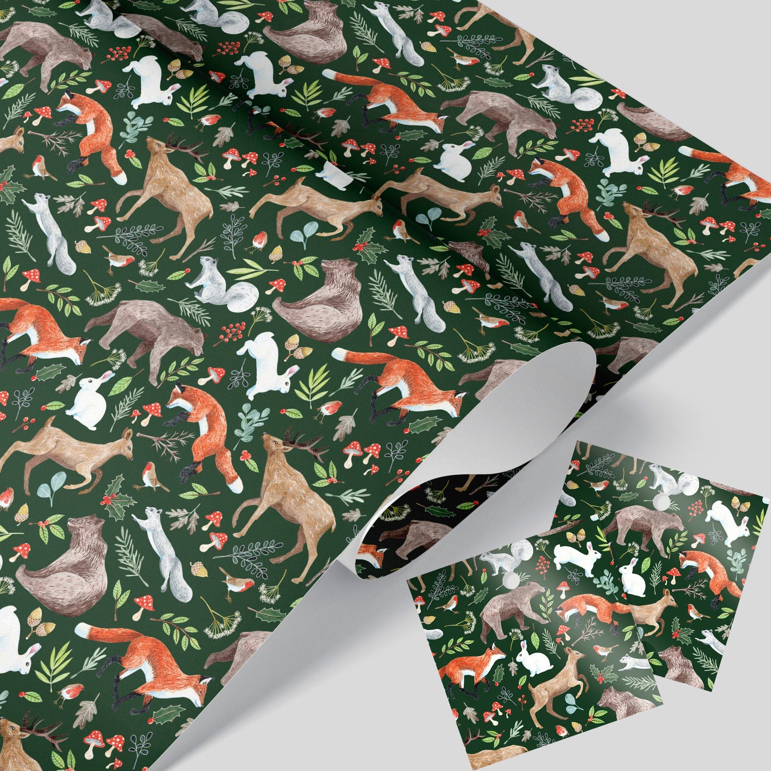 Wrapping paper with a fairytale woodland theme featuring animals like foxes, deer, bears, rabbits, and squirrels among Christmas foliage on a dark green background.
