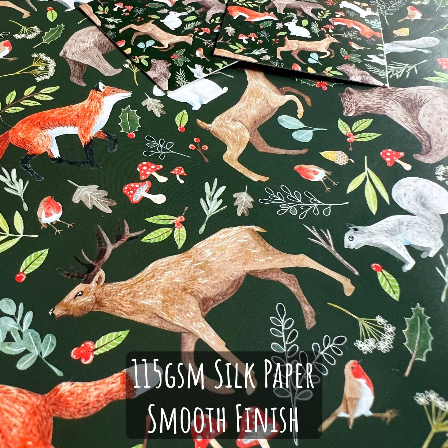 Woodland Christmas Wrapping Paper close up showing the details and illustrations on the paper with the text 115gsm silk paper smooth finish.