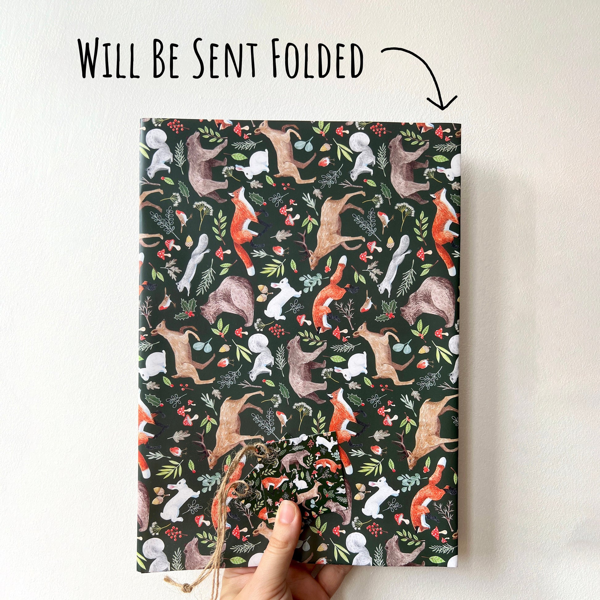 Woodland Christmas Wrapping Paper folded into an A4 size to show how it will be posted. with the text will be sent folded.