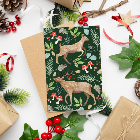 Christmas-themed card with deer design surrounded by festive decorations on a white background