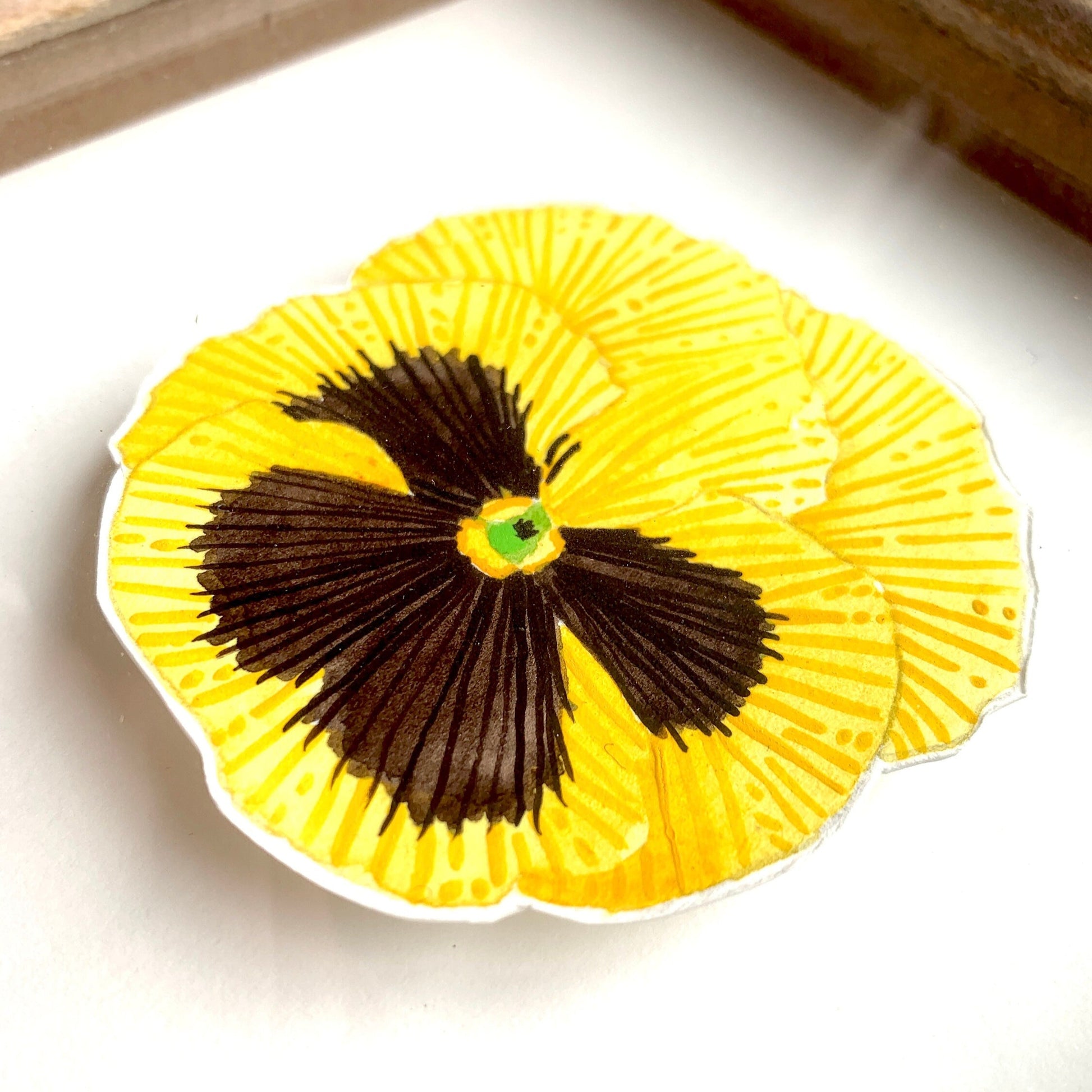 Original floral art by Kelly Attenborough featuring yellow pansy flower with a black center