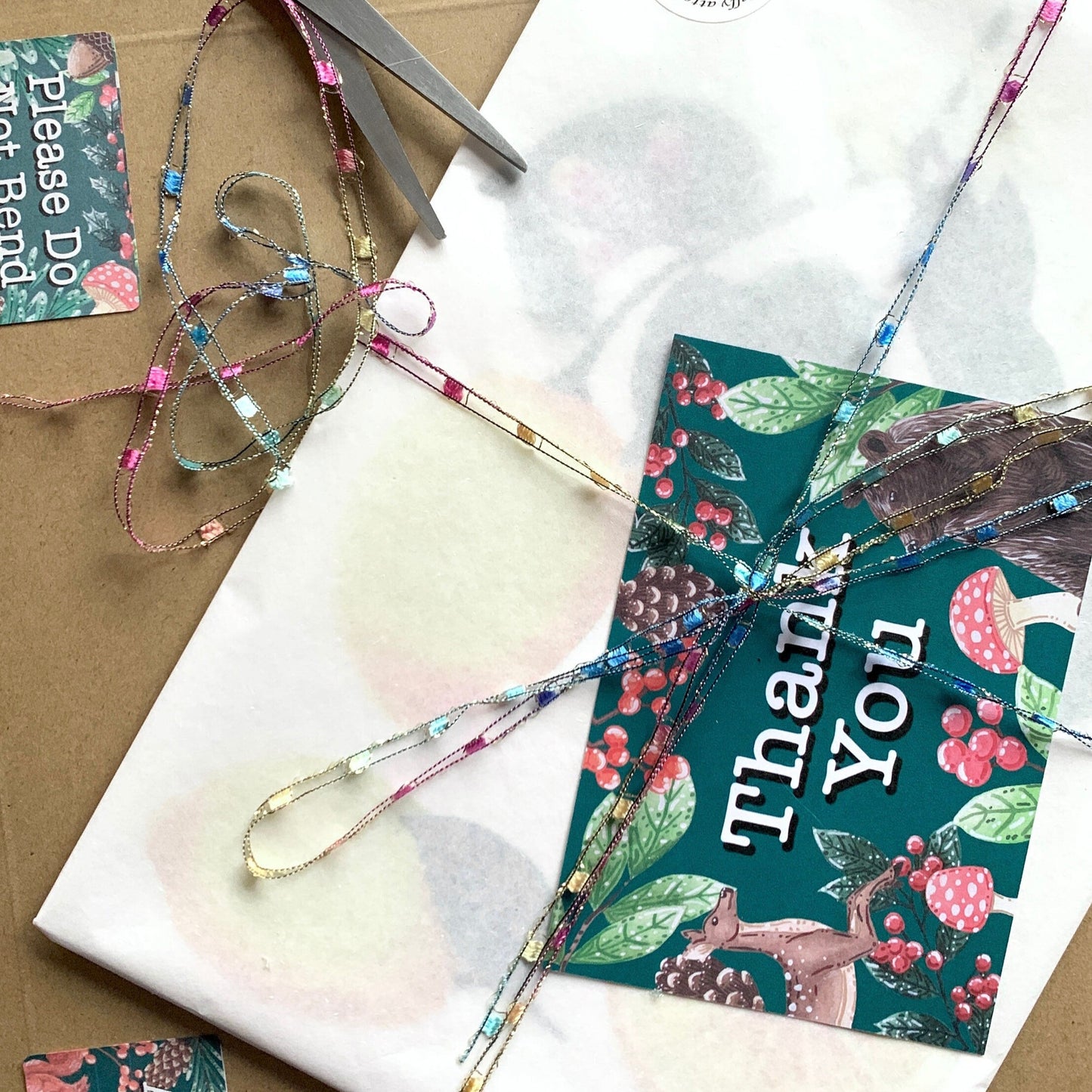 showing how art work will be sent. wrapped up in biodegradable tissue with a backing broad. and then placed in to a sturdy thick card envelope.