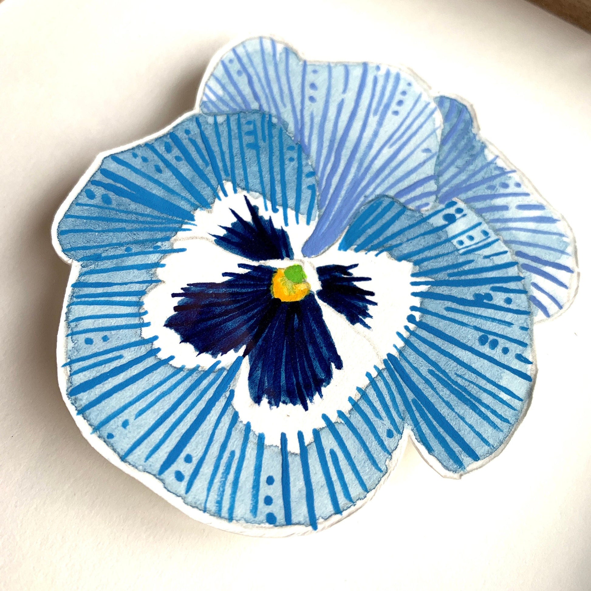 showing a close up of a light blue and white pansy flower painting. showing the details and textures of the painting