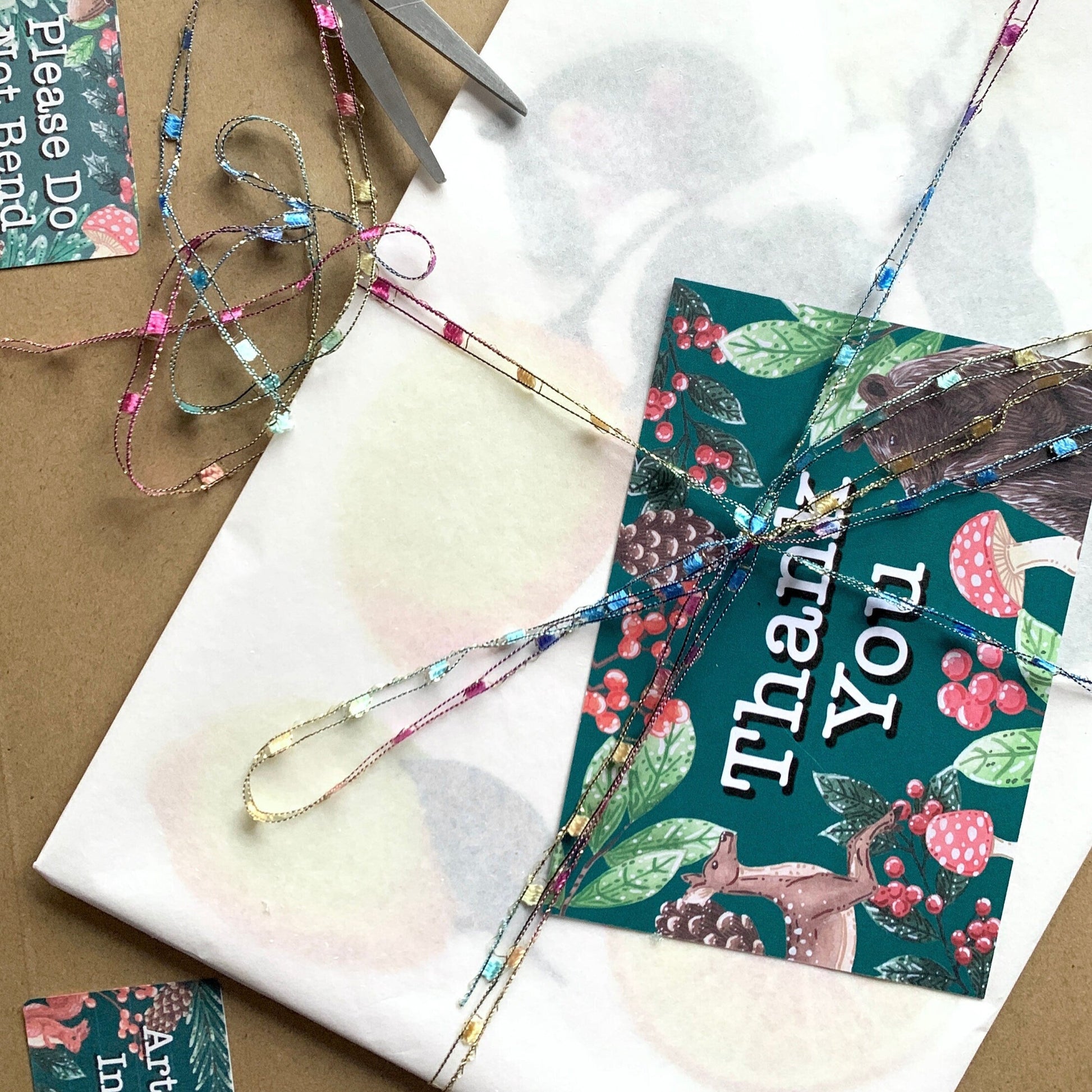 showing the packing the artwork will be sent in. Artwork wrapped in tissue paper with a backing broad and placed in a hard backed envelop with a thank you card